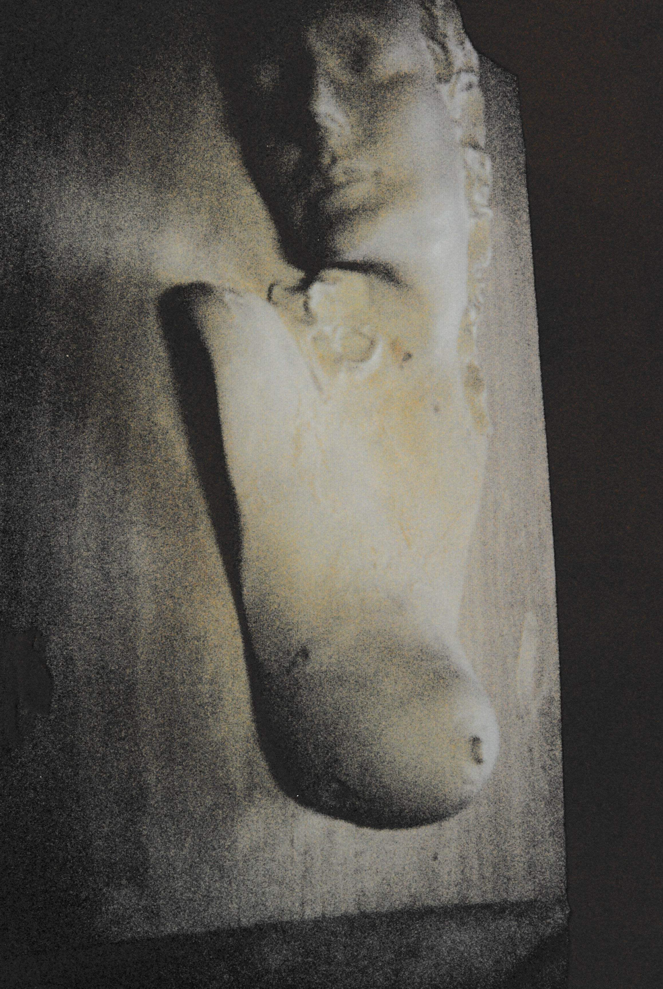 Ceramic relief sculpture of a female figure emerging from a vertical slab, the face and torso partially embedded within the surrounding surface.