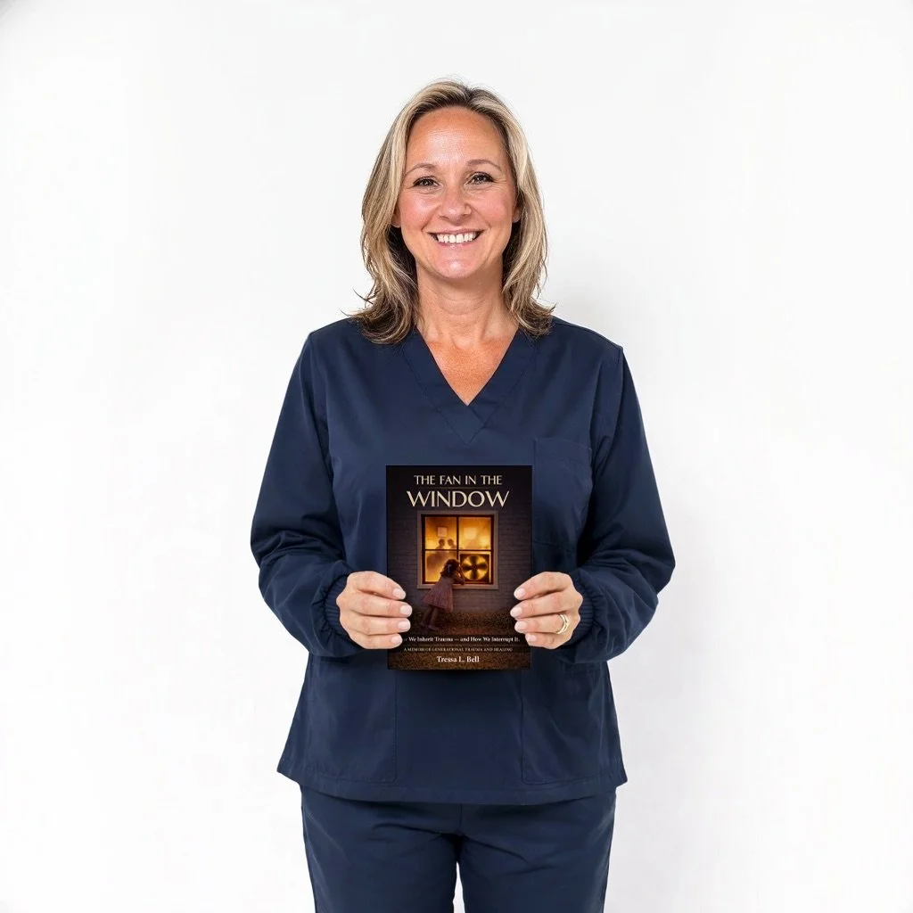 A smiling woman in navy medical scrubs holding a book titled 'The Fan in the Window' against a plain white background.
