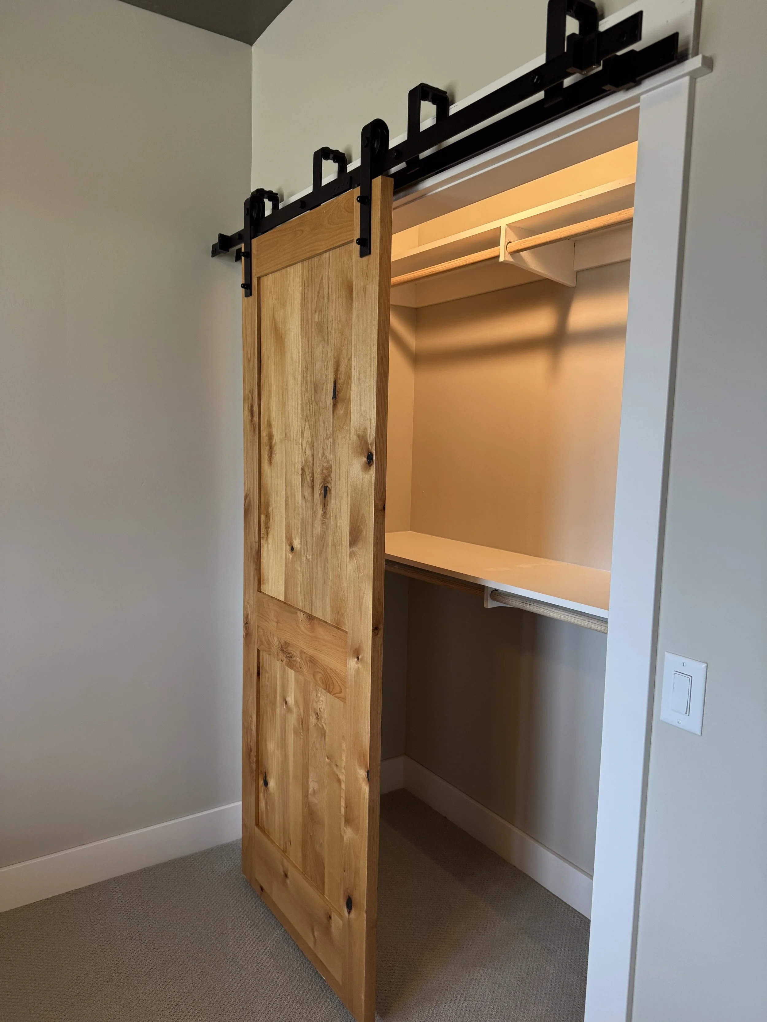 Custom barn door closet with built-in storage — luxury interior finishing by Mihelich Custom Builders near Butte, MT