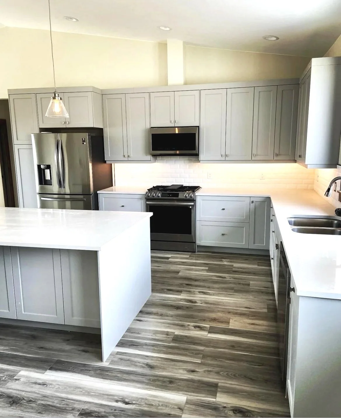 Open-concept custom kitchen with pendant lighting and designer finishes — Montana custom home construction by Mihelich Custom Builders.