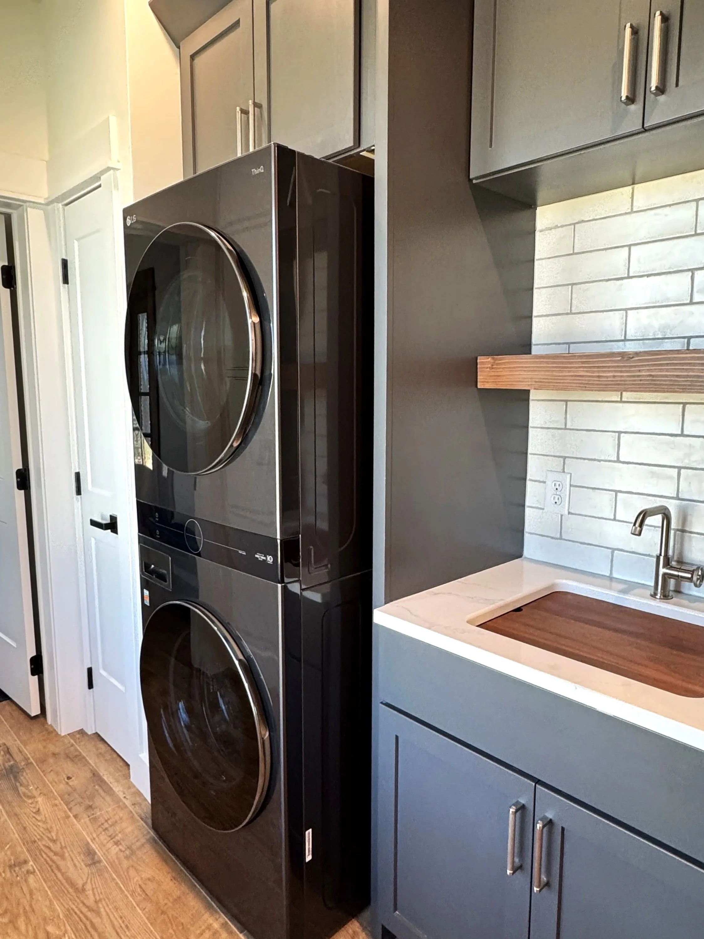 Custom butler’s pantry with farmhouse sink and designer tile backsplash — luxury kitchen by Mihelich Custom Builders near Butte, MT.
