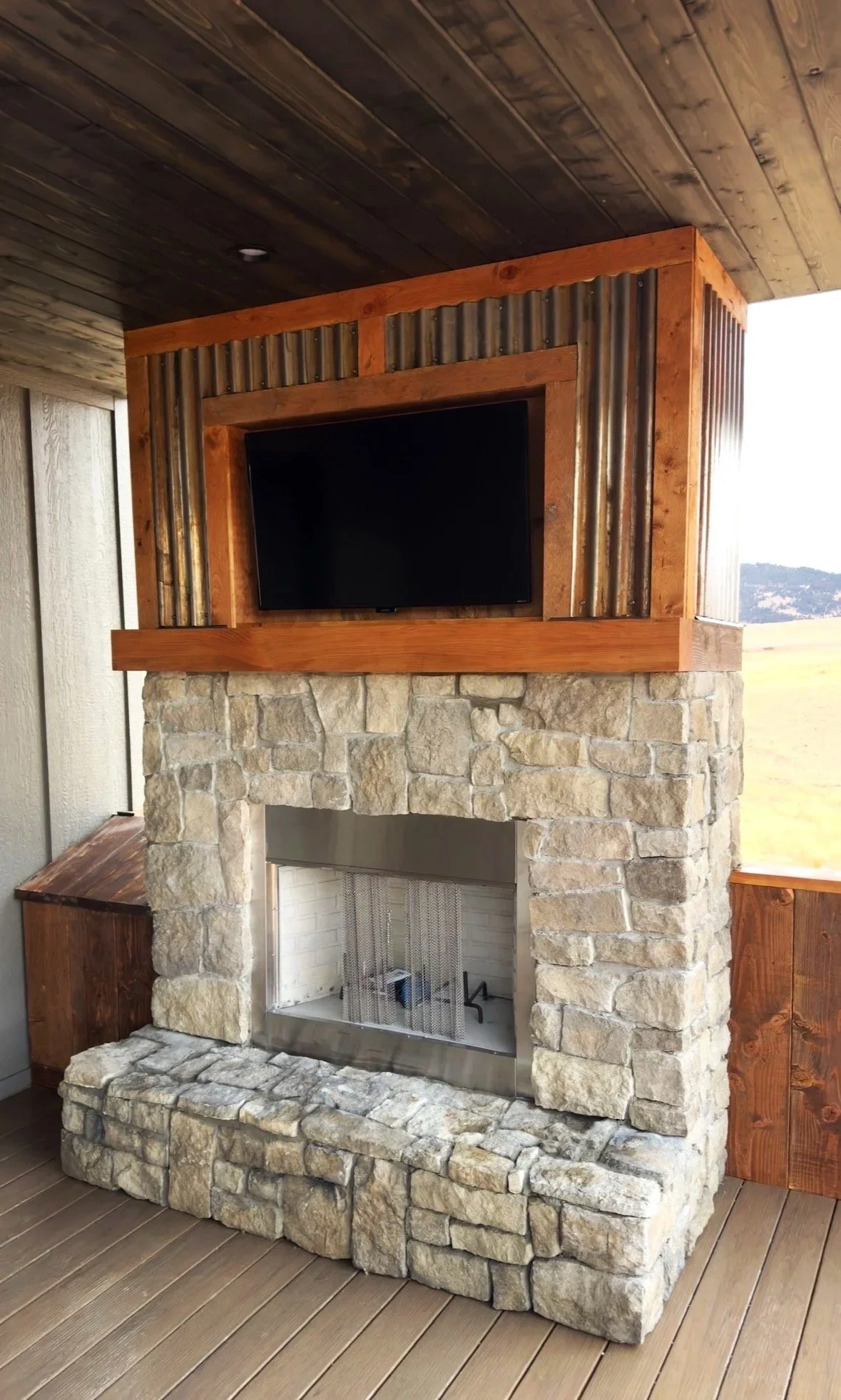 Custom stone fireplace detail with warm wood accents — signature craftsmanship by Mihelich Custom Builders near Butte, MT.