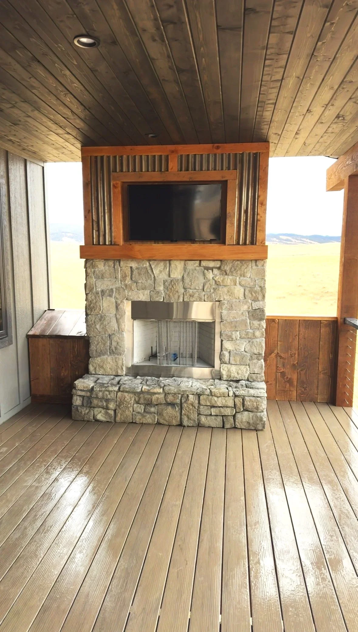 Stone fireplace with TV, wide shot
Custom stone fireplace with wood mantel and mounted TV — luxury custom home builder Mihelich Custom Builders, Buxton, Montana.