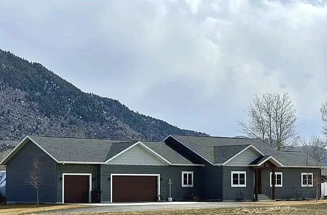 Custom home exterior set against Butte’s iconic mountain ridge — luxury home construction by Mihelich Custom Builders, Butte, MT.