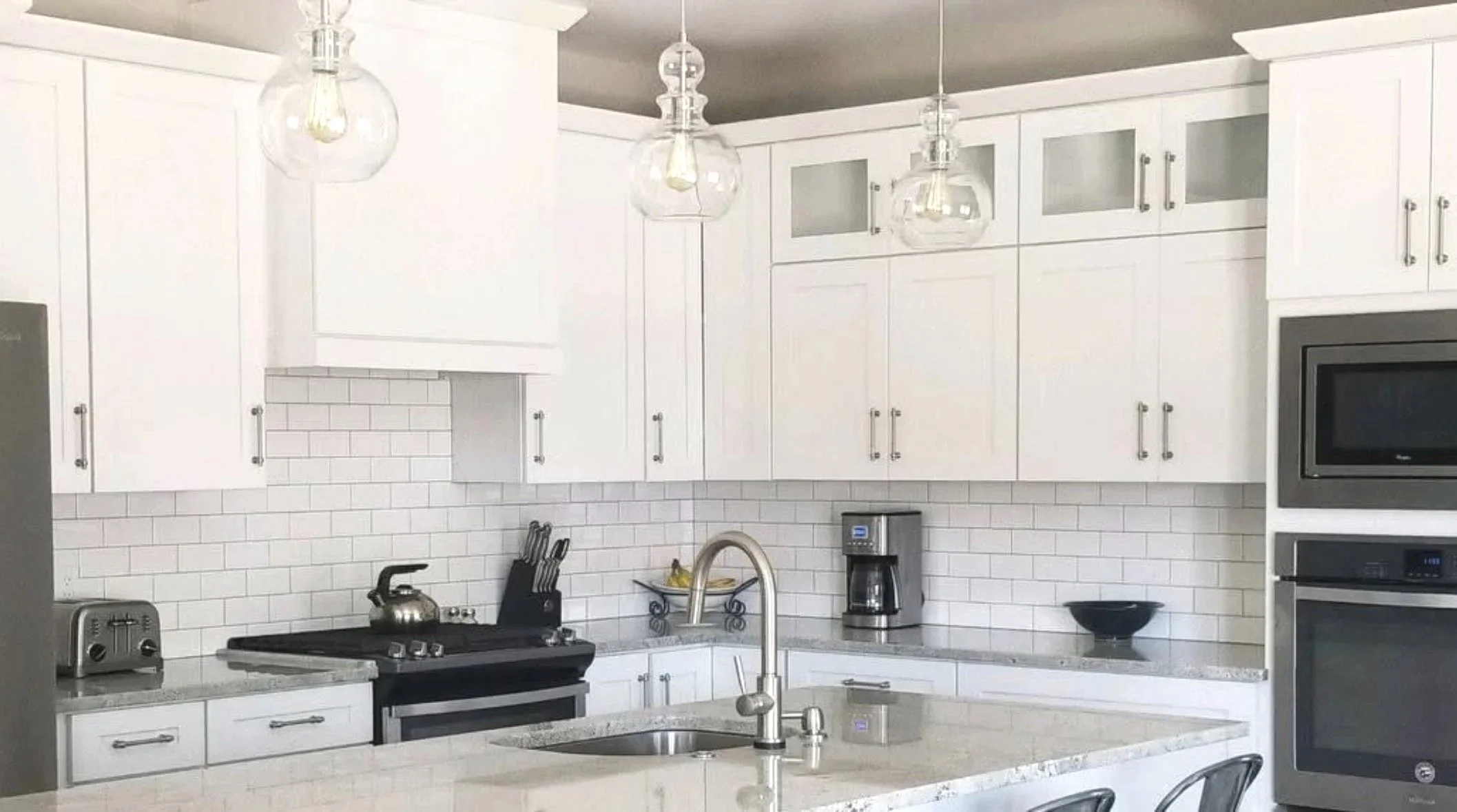Custom kitchen with designer pendant lighting and quality cabinetry — Mihelich Custom Builders, luxury home builder in Butte, MT.