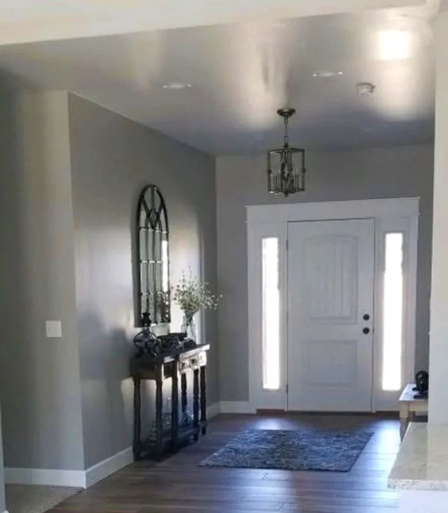 Custom open-concept entry and dining area with tiled floors and vaulted ceiling — Mihelich Custom Builders, Butte, Montana.