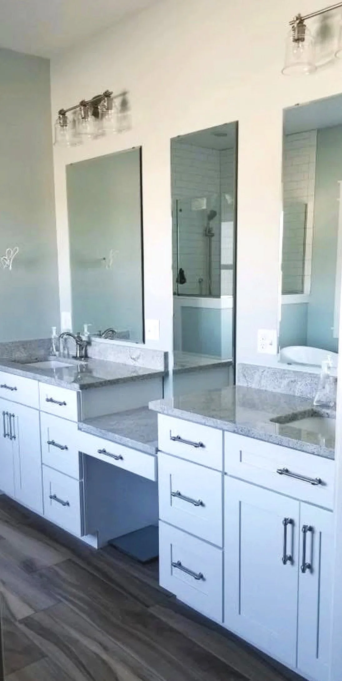 Custom kitchen with white cabinetry, granite countertops, and stainless appliances — luxury home construction in Butte, MT by Mihelich Custom Builders.