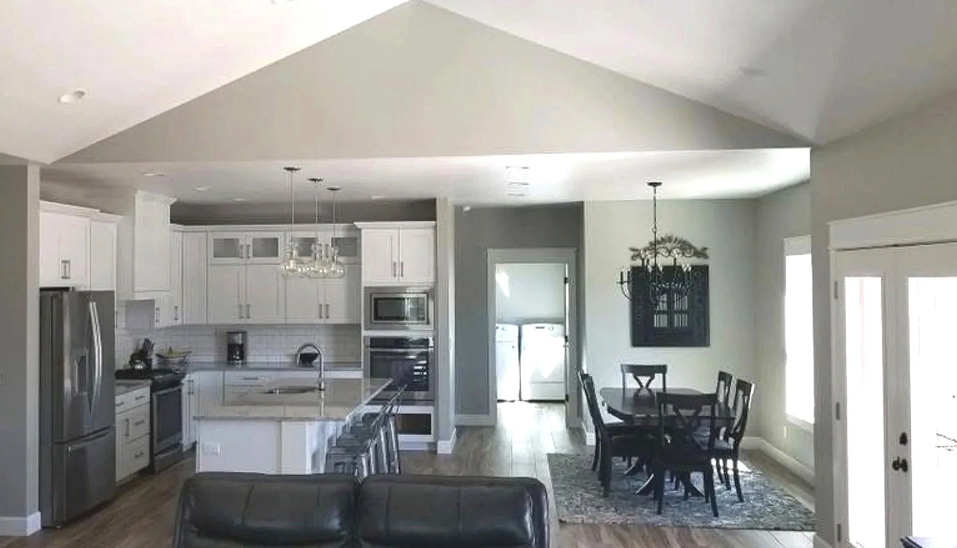 Custom open-concept kitchen and dining area with vaulted ceiling and designer finishes — Mihelich Custom Builders, Butte, Montana