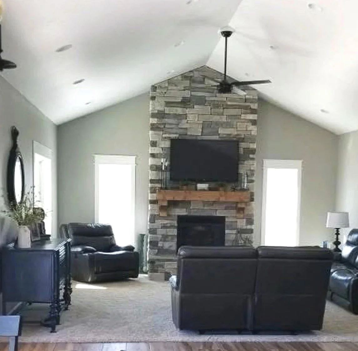 Custom great room with vaulted ceiling, stone fireplace, and tiled floors — luxury custom home builder Mihelich Custom Builders, Butte, MT.