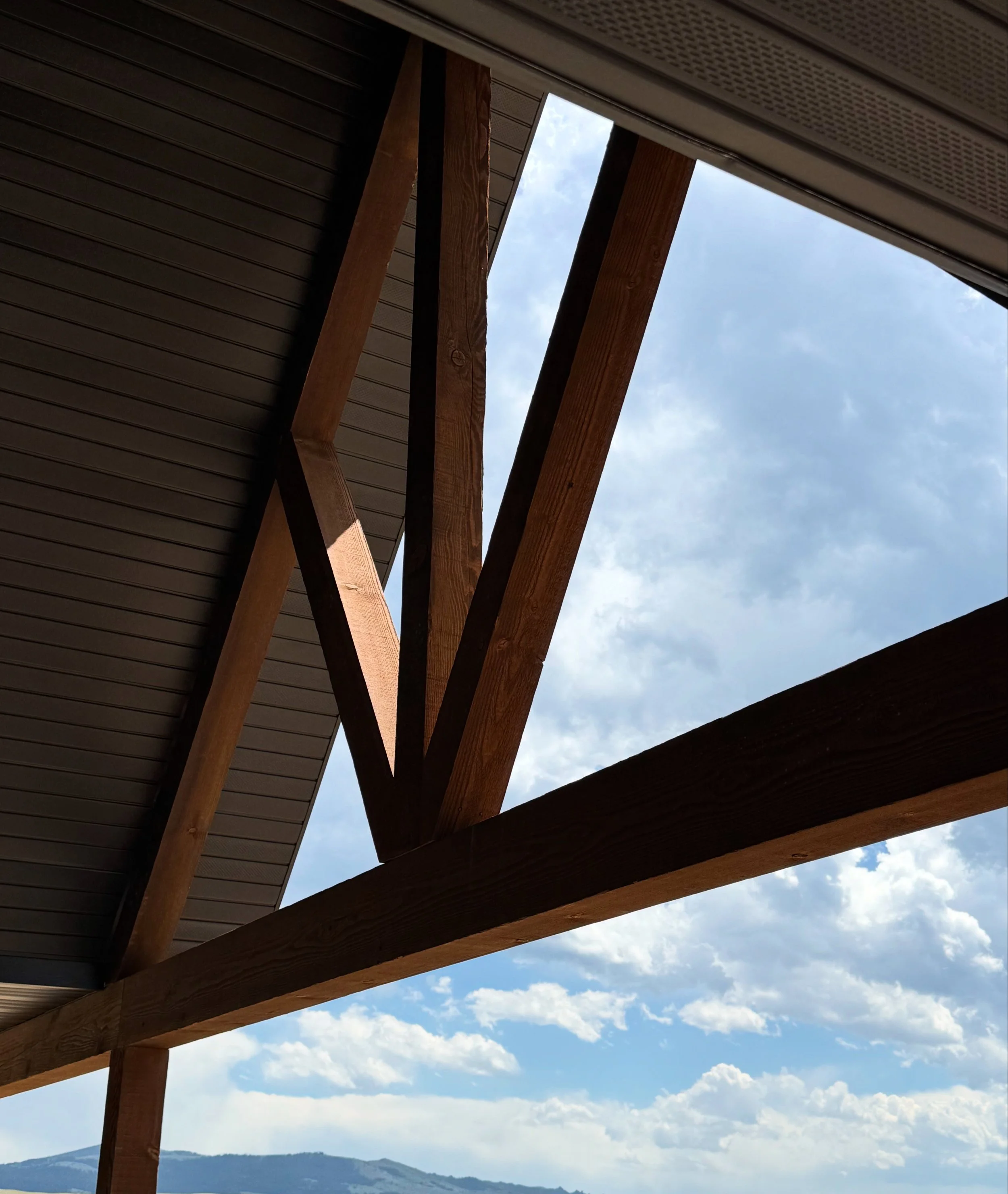 Custom timber frame Montana home exterior under Big Sky — luxury construction by Mihelich Custom Builders near Butte.