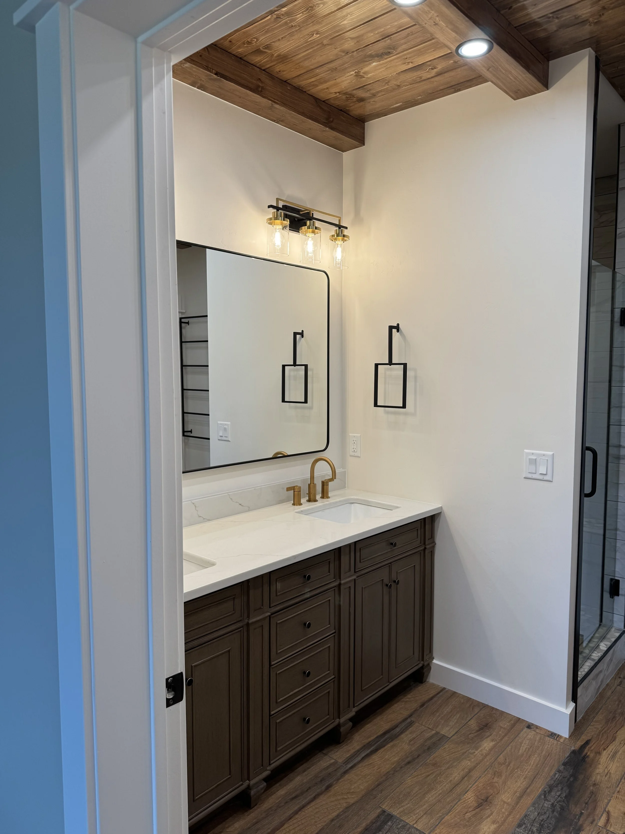 Custom primary bathroom double vanity with upscale fixtures — high-end Montana home by Mihelich Custom Builders near Butte.