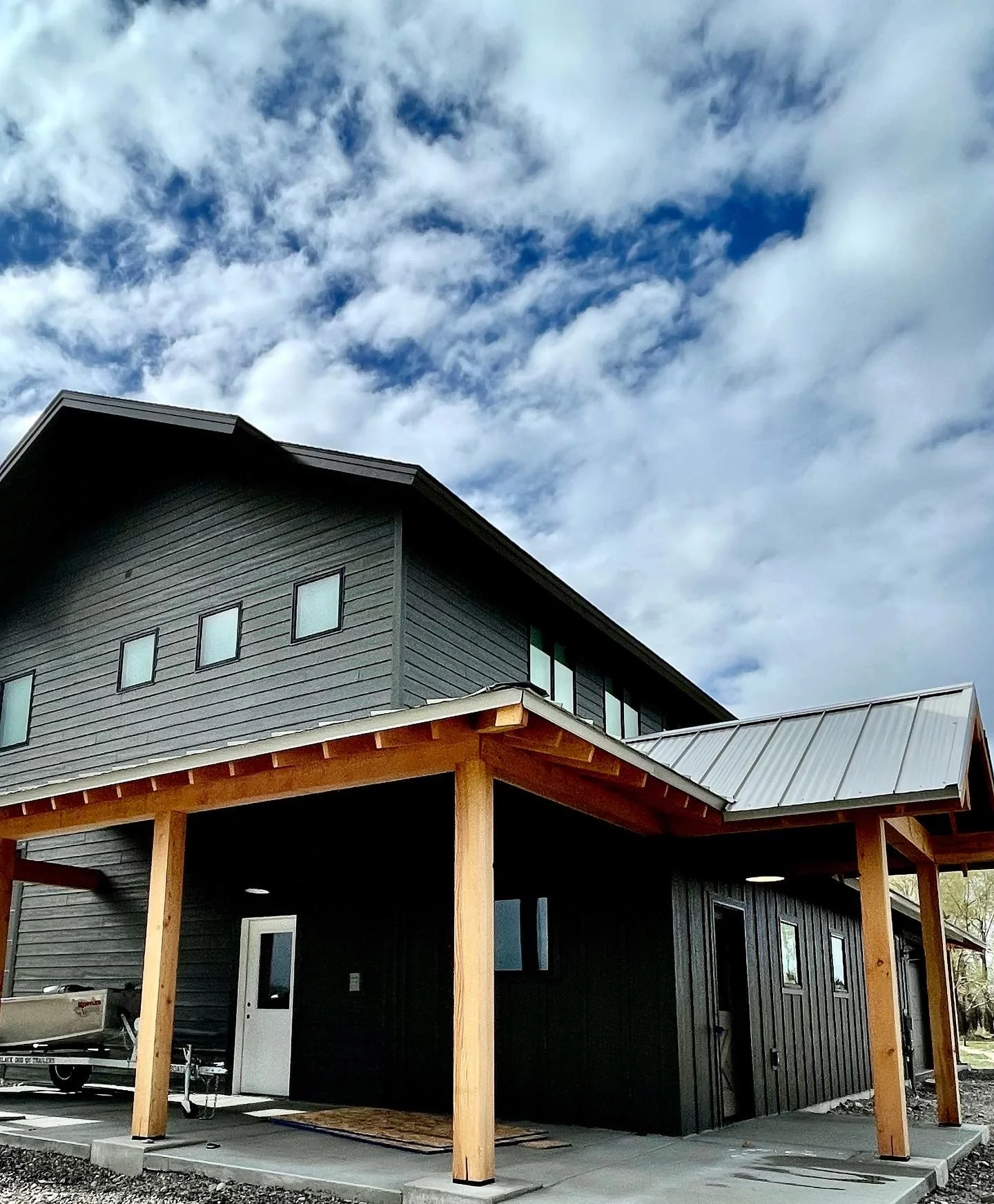 Award-worthy barndominium design set against a sweeping Montana sky — luxury custom construction by Mihelich Custom Builders.