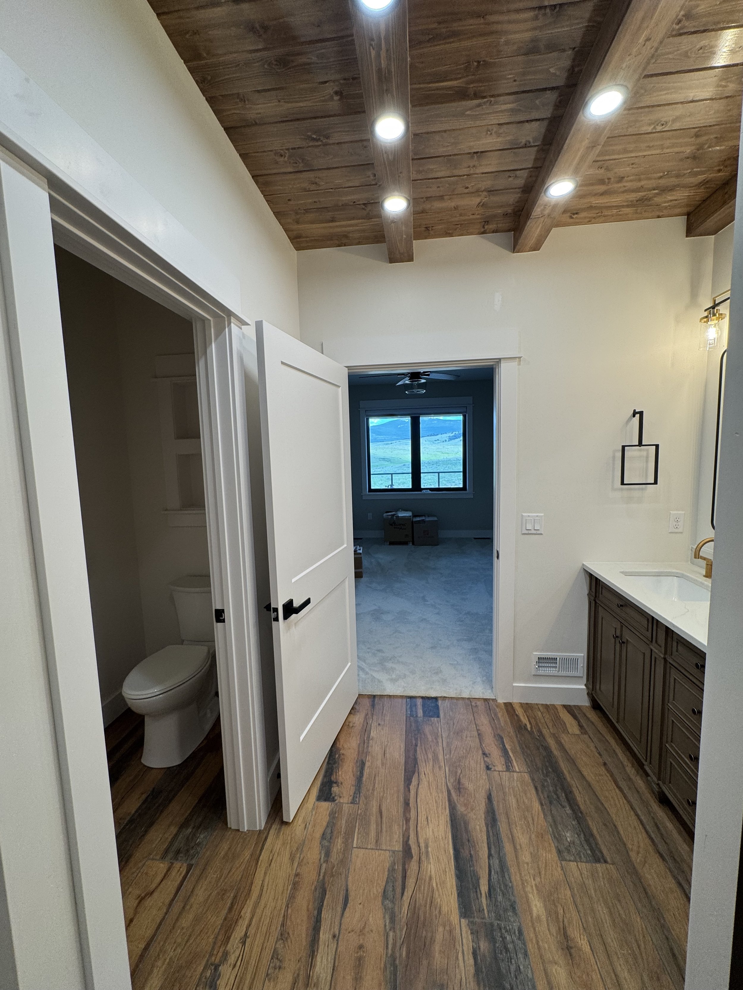 Custom entry hallway with hardwood floors and quality trim — luxury Montana home construction by Mihelich Custom Builders near Butte.