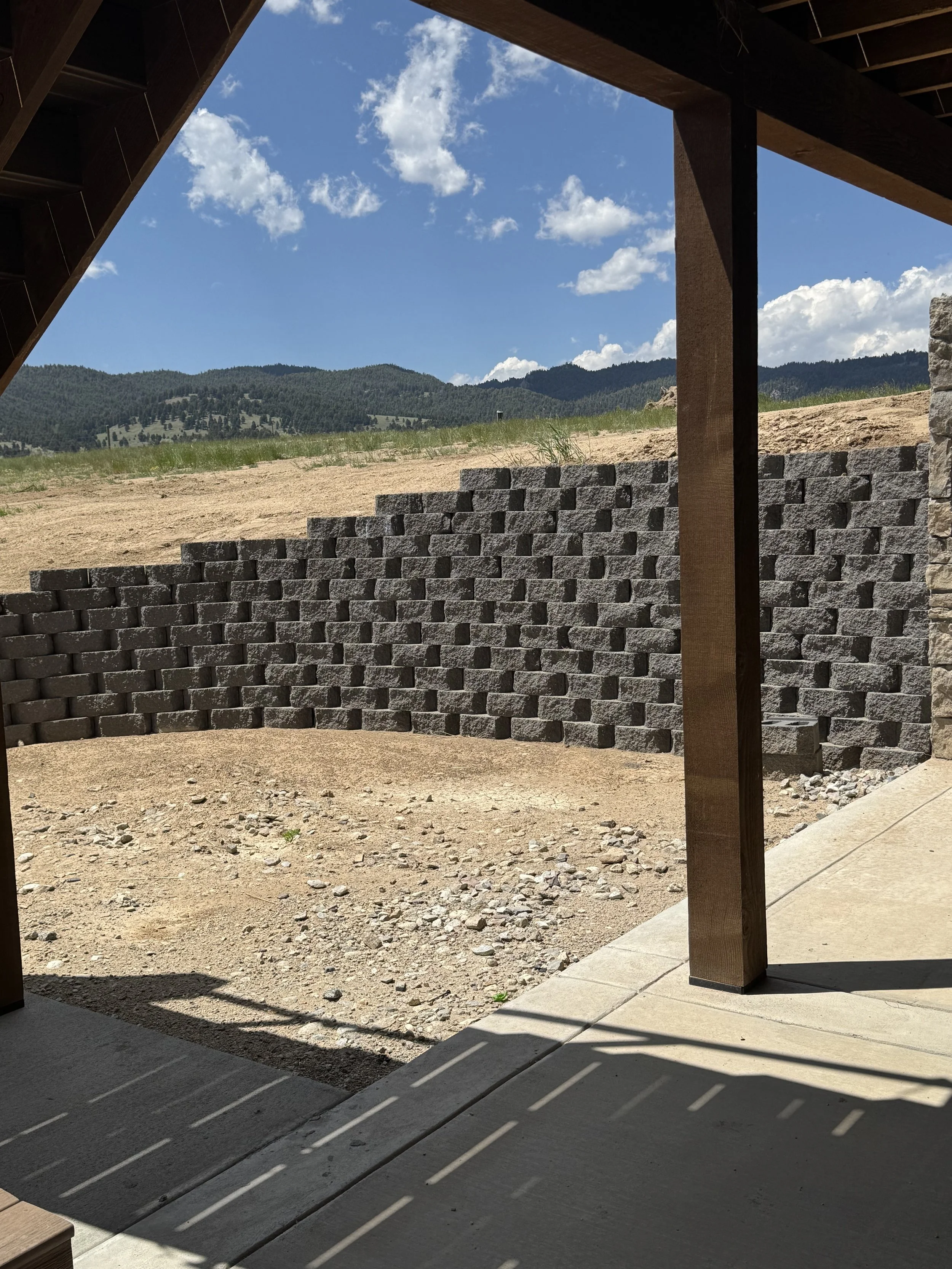 Custom stone retaining wall and site work — full-service custom home construction near Butte, MT by Mihelich Custom Builders.