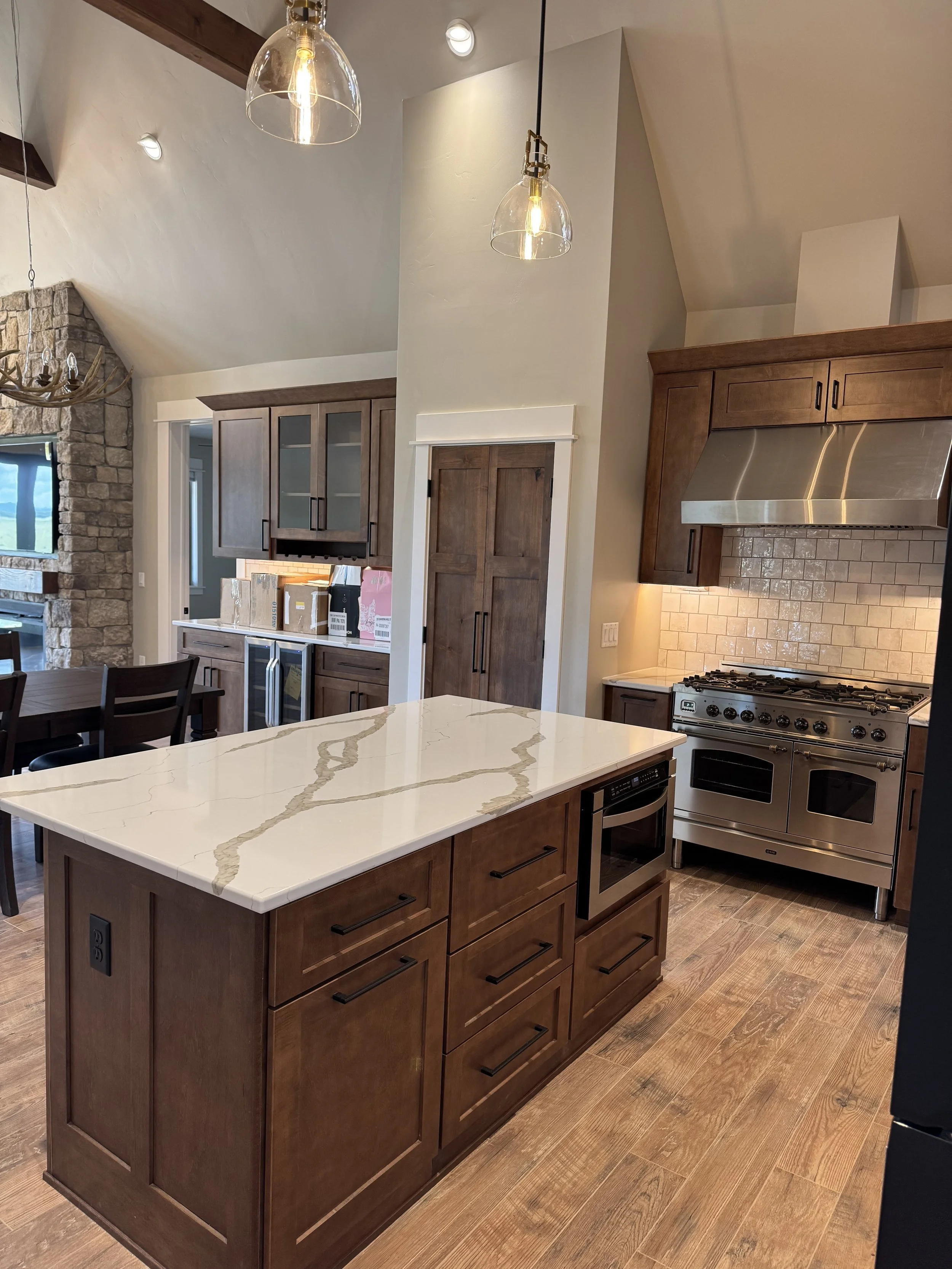Custom kitchen with large center island and premium countertops — luxury Montana home builder Mihelich Custom Builders near Butte, MT.
