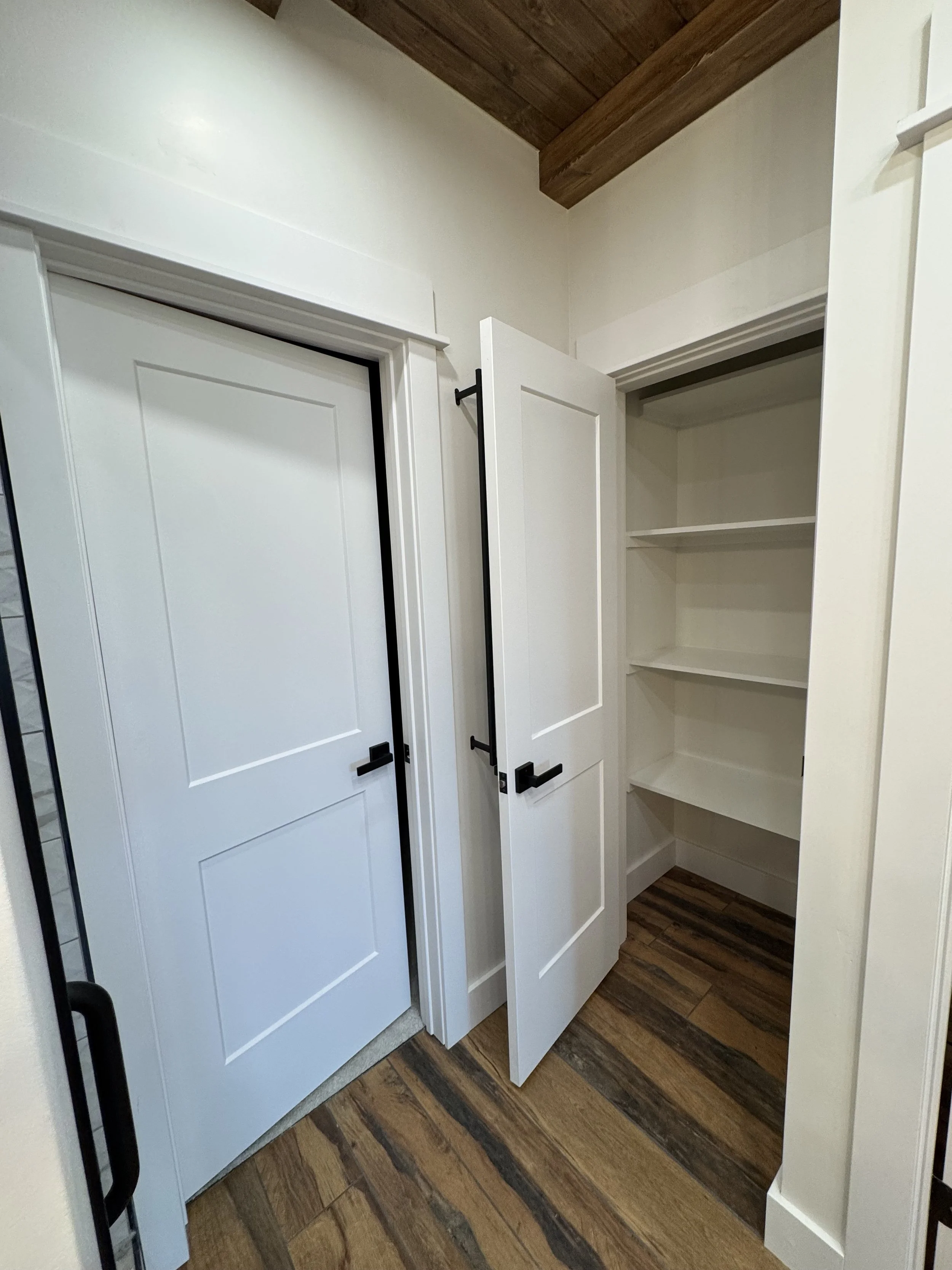 Custom white built-in shelving and storage — luxury interior millwork by Mihelich Custom Builders near Butte, MT.