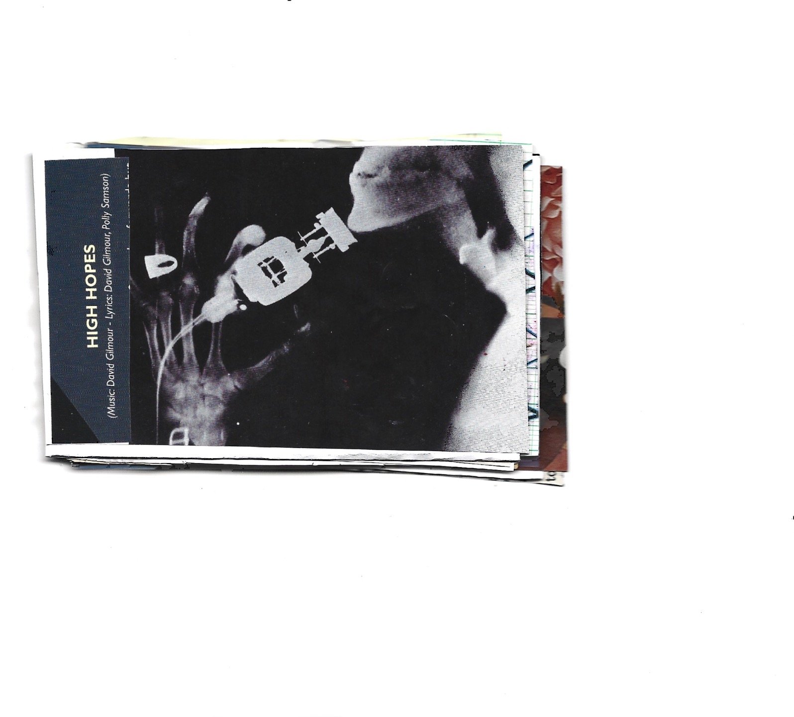 Stack of printed pages with the top page featuring a black-and-white image of a person playing the guitar, titled 'High Hopes,' with the songwriter credited as David Gilmour.