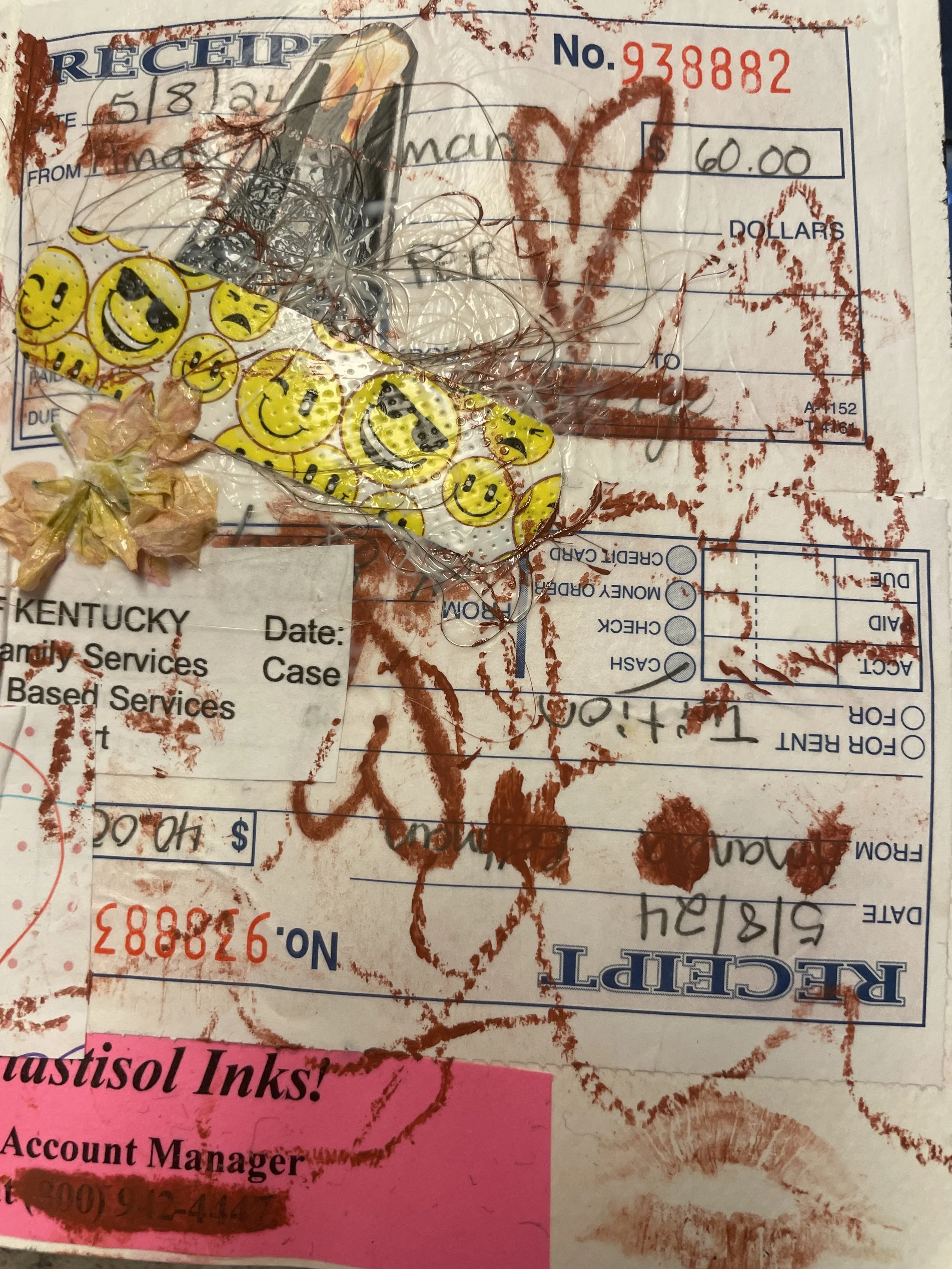 Assorted wrapped candies and a partially visible receipt on a dirty surface.