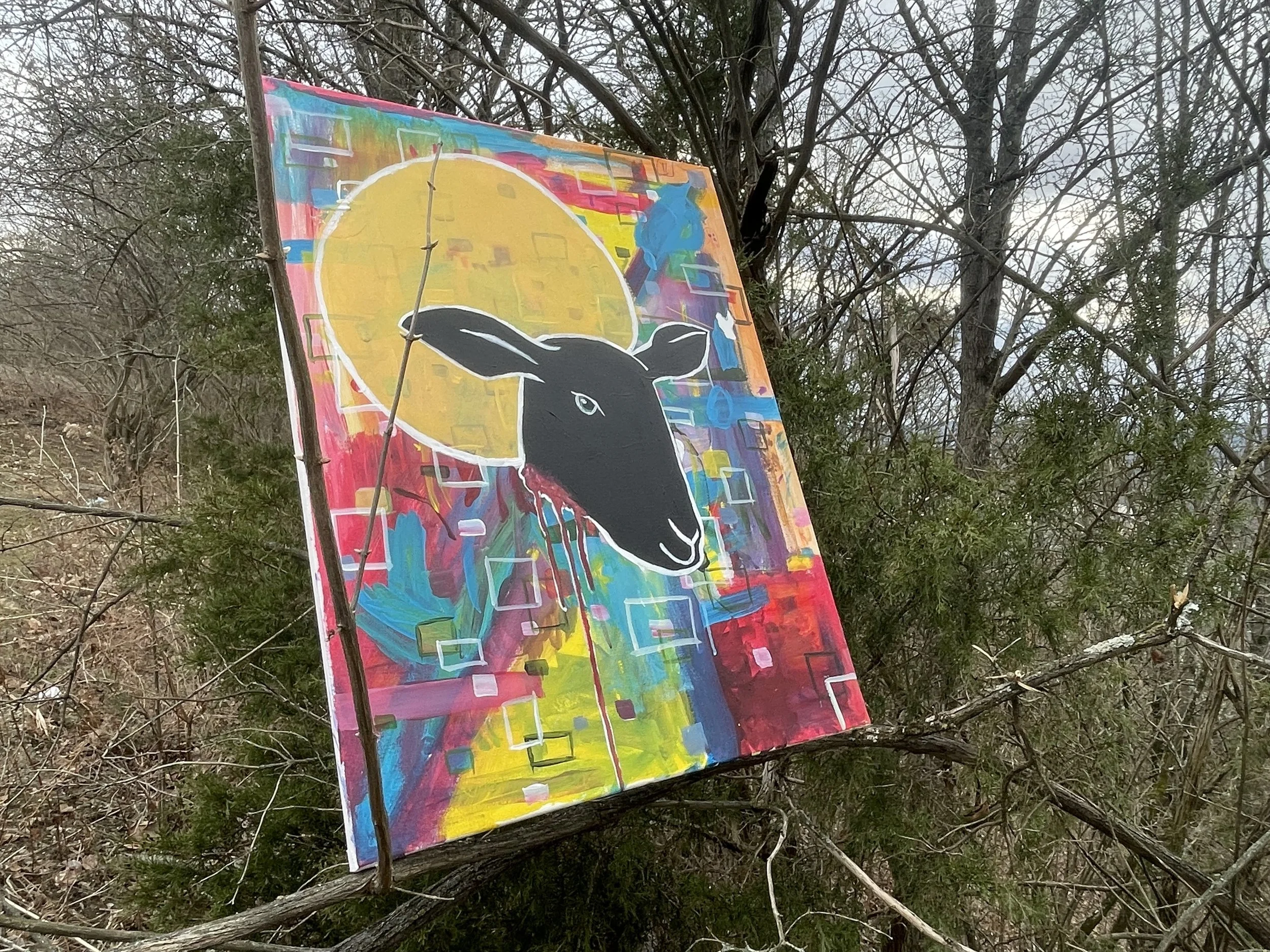 Colorful abstract painting of a black rabbit's head with white outlines, set against a vibrant geometric background with yellow moon and crystal shapes.