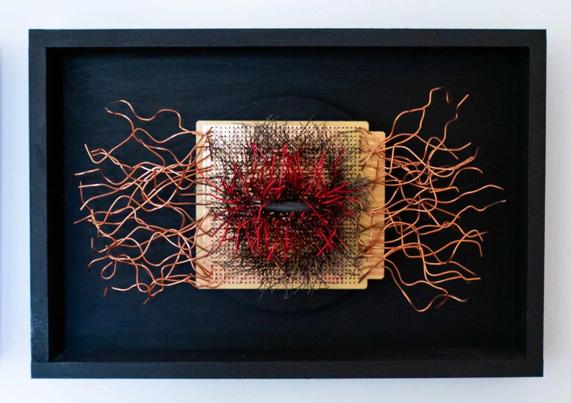 Deep Within - A meditative state of looking inward. Wood frame, copper wire, red wire, circuit board, black stone. 8” x 12” x 2.5”  2022