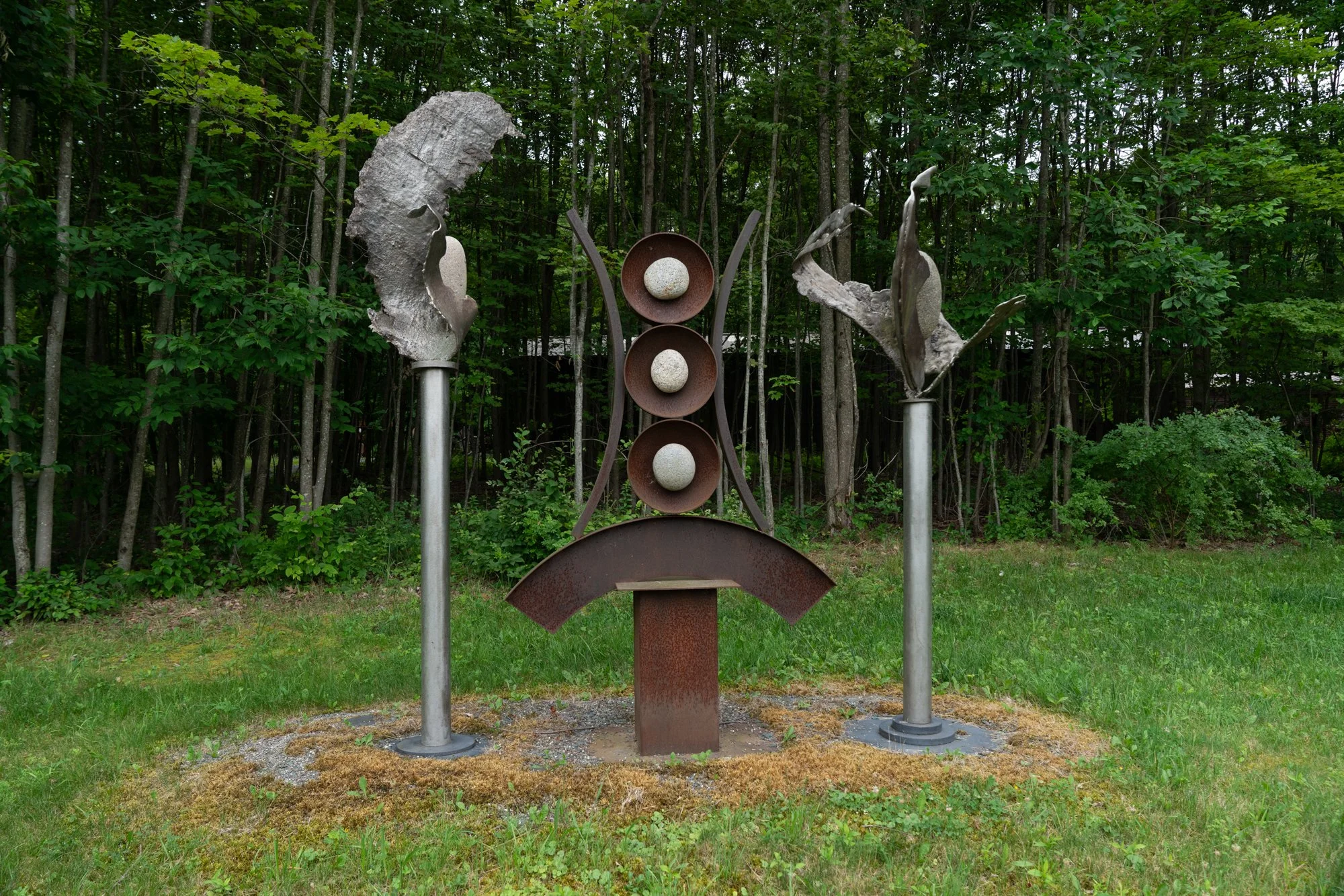 Artifacts I - Inspired by the industrial cast stainless steel forms from a local defunct steel manufacturing plant that serve as artifacts from that time period. Welded steel, cast stainless steel, rocks. Overall 9’ x 11’ x 3’.  2009