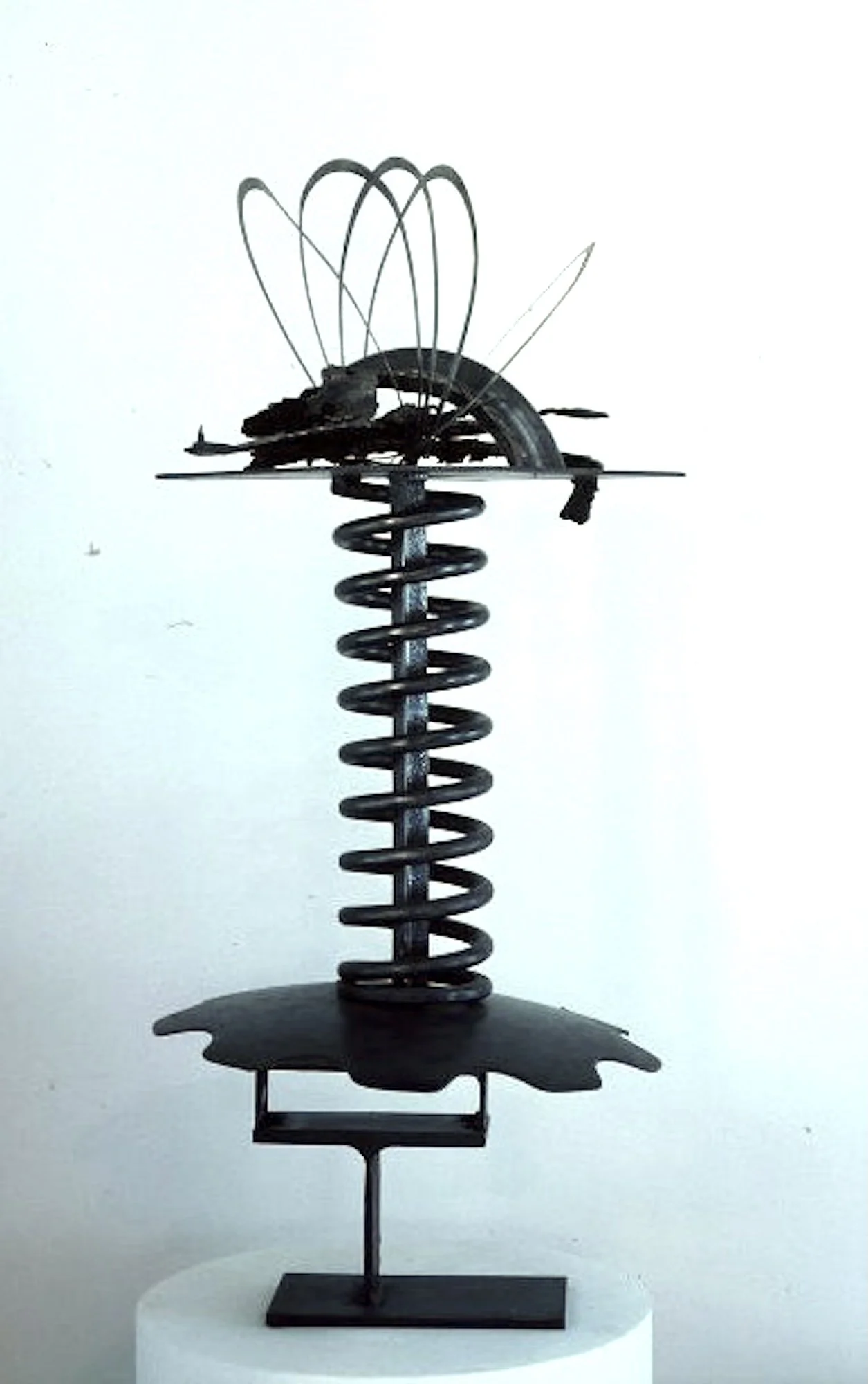 Shock Absorbed  - Inspired by the industrial spring used to create this piece. Welded steel, plow disc, cast stainless steel. 40” x 18” x 18”. 1986 ( in the permanent collection at Bonaventure University)
