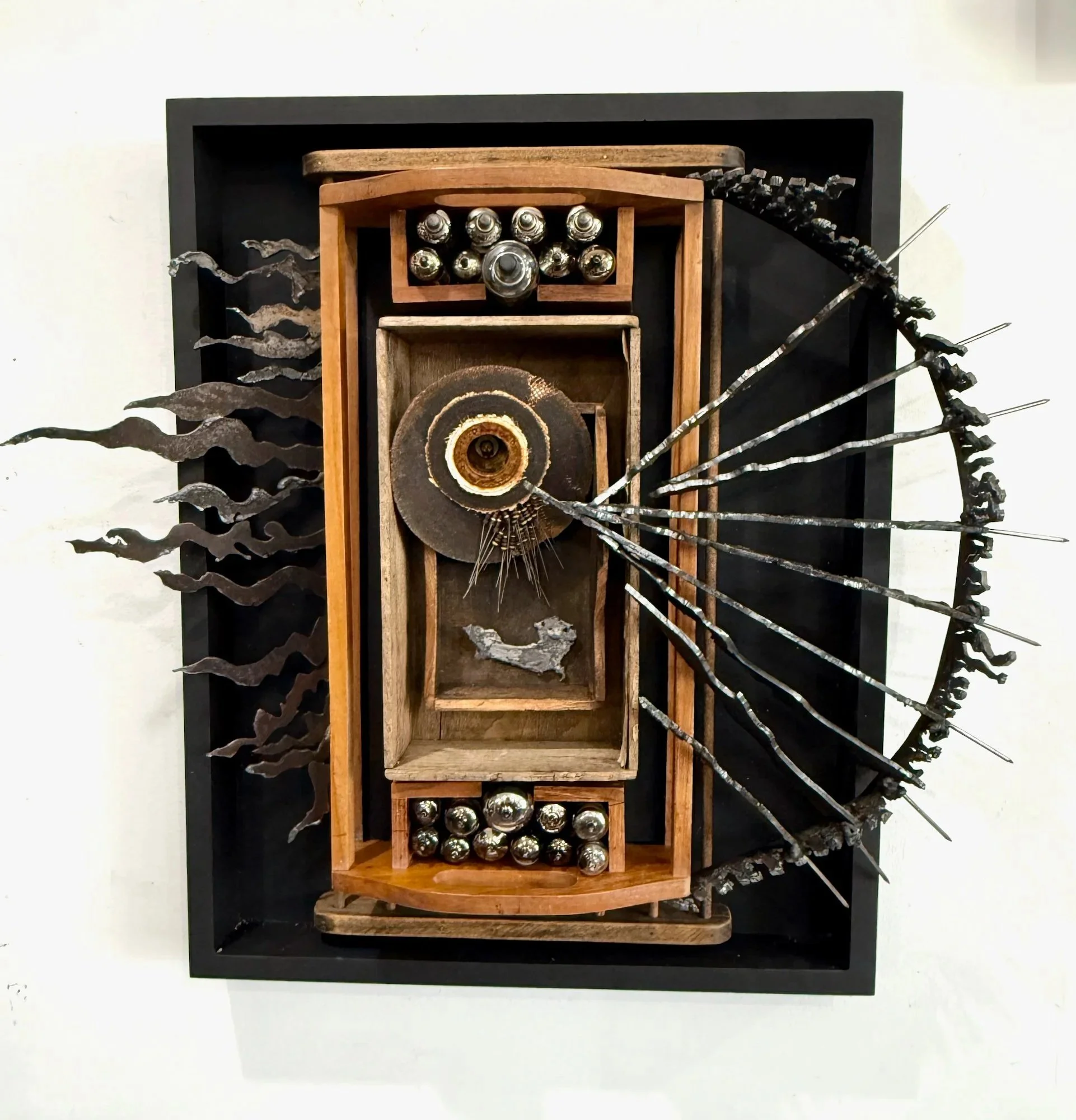 Attack  - 2026 - wall relief - wood, plasma-cut steel, test tubes, sanding discs. 20" x 23" x 6"