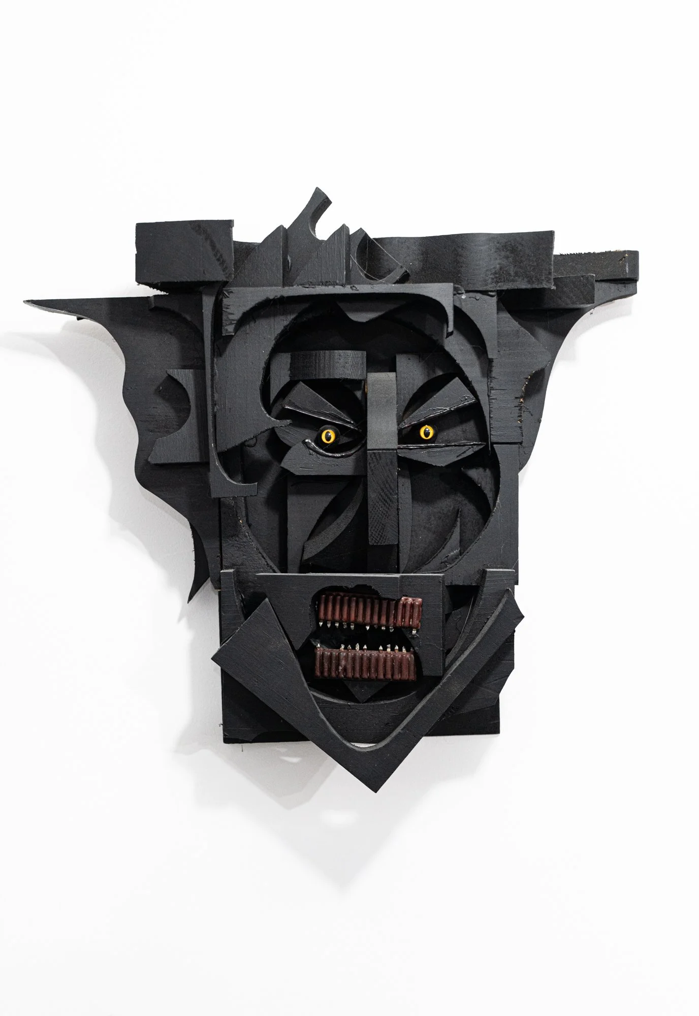 Wood Mask - “ Warrior” Created from wood shop scrap wood. Wood, plastic eyes, electrical components. 16” x 16” x 3”. 2011