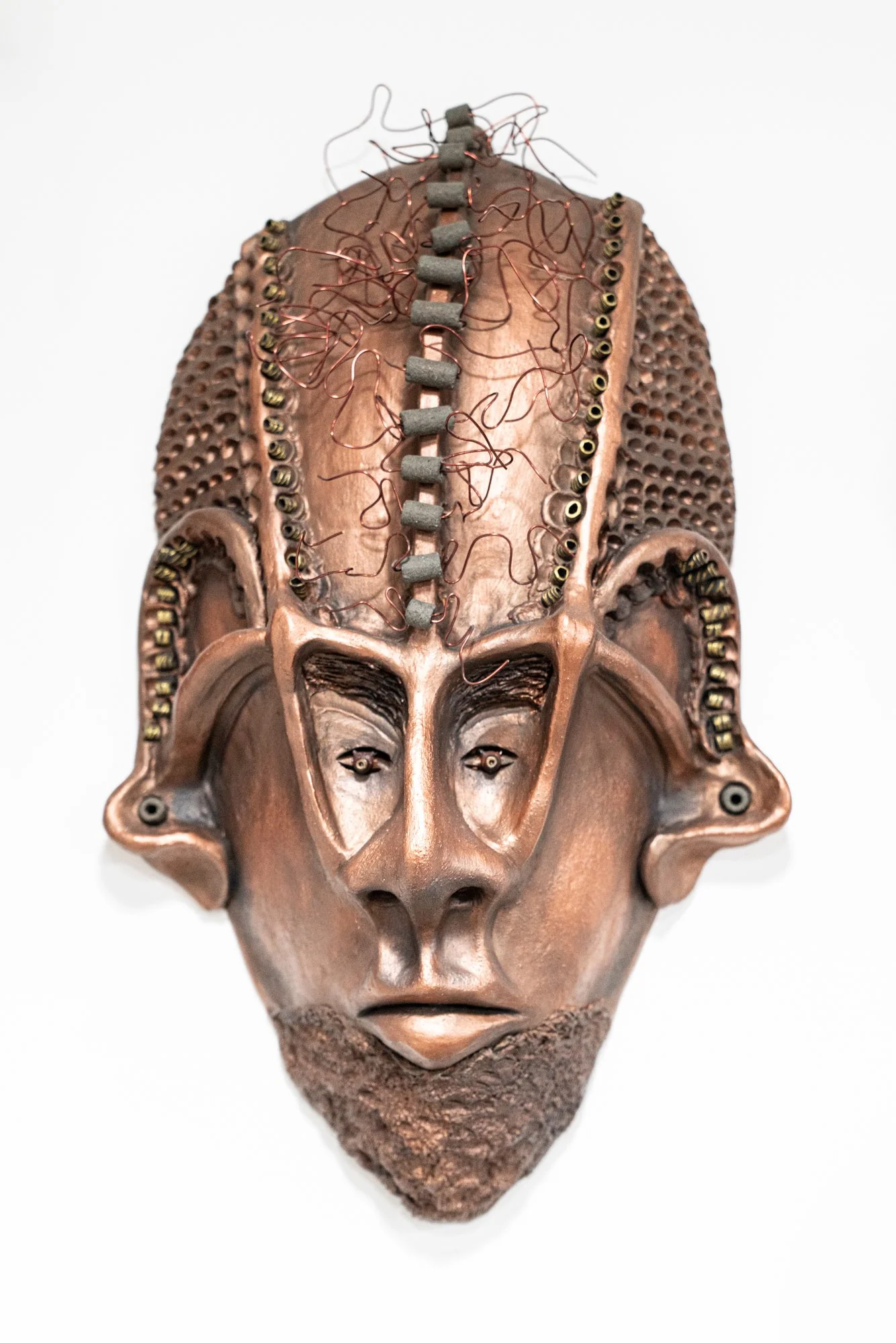 Aztec Warrior Mask - Modeled clay adorned with beads and copper Rivets. 19” x  12” x 5”