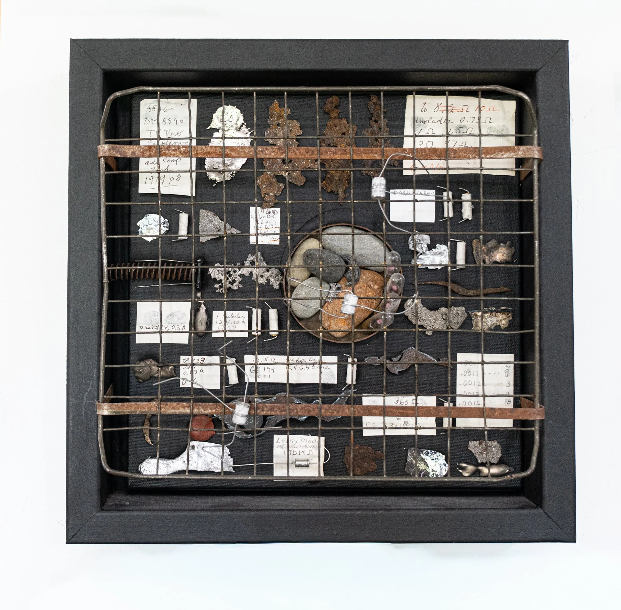Formula - Inspired by a research chemist friend. I created a specific, prescribed combination of objects to invent this composition. Wood, steel, slips of paper from a chemist friend, stones, rusty steel, wire, bronze, electrical components. 12” x 12
