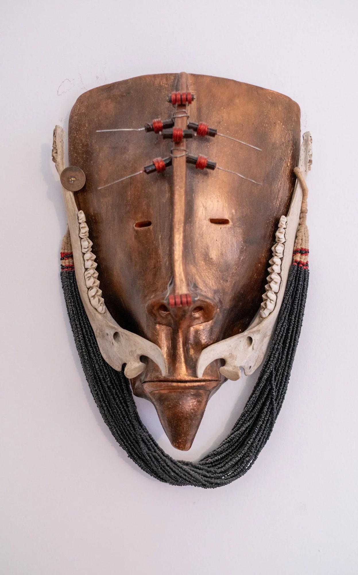 Jaw Bone Mask - Intuitively created. Found deer jaw bones, transistors, beaded necklace. 12” x 10” x 5”. 2005 