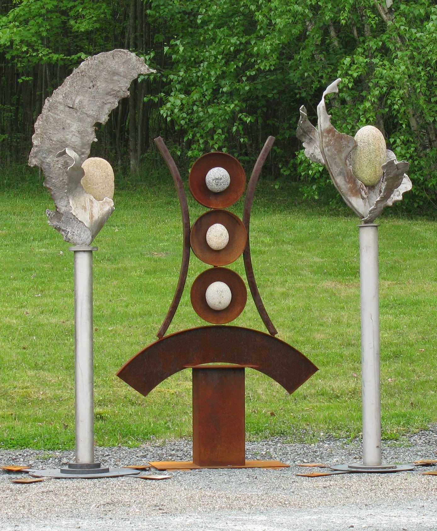 Artifacts I - Inspired by the industrial cast stainless steel forms from a local defunct steel manufacturing plant that serve as artifacts from that time period. Welded steel, cast stainless steel, rocks. Overall 9’ x 11’ x 3’.  2009