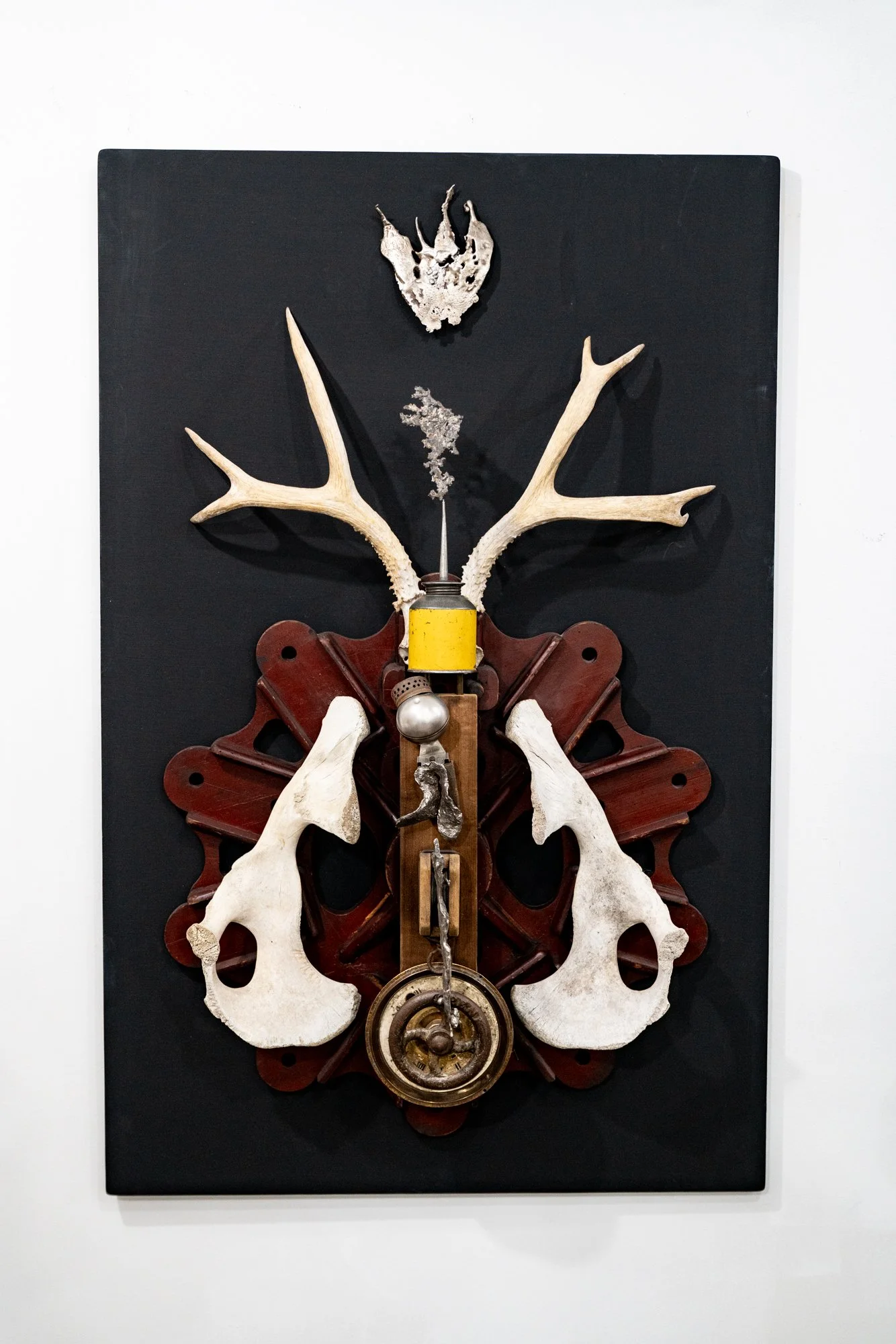 Terminal Evidence - Inspired by that which remains. Deer antlers, cow bones, oil can, clock face, cast stainless steel, wood pattern pieces. 46” x 31” x 10”. 2019