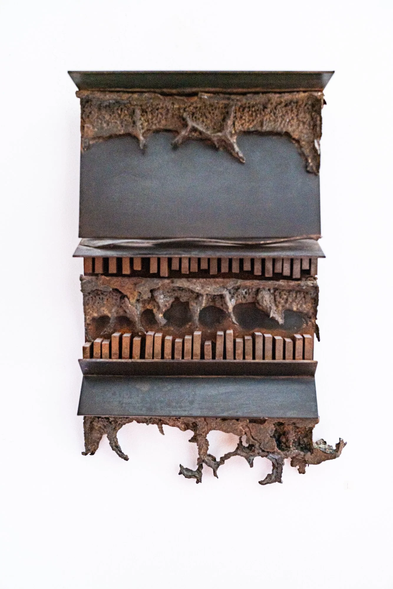 Three Layers Down - Inspired by earth’s layers. This was the first sculpture that I welded. Cast stainless steel & welded steel.19” x 12.5” x 4”. 1978