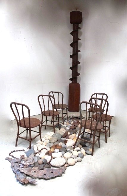Summons - Inspired by the concept of being required to attend a hearing or summoned to appear before an authority. Yet to be publicly displayed. Vintage industrial auger, deconstructed propane tanks, vintage metal chairs, chain, cast stainless, rocks