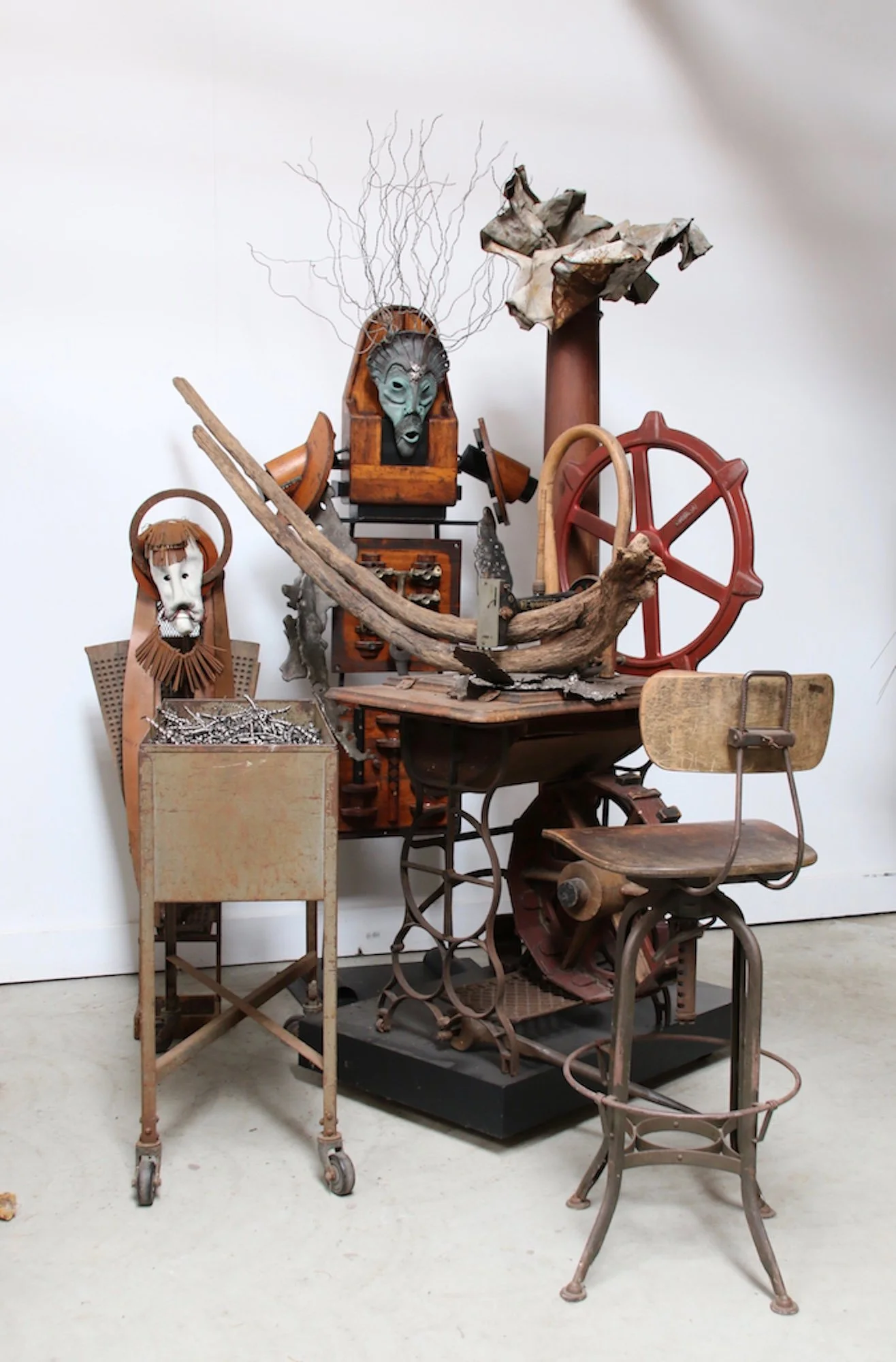 
Faith Mills - Inspired by memories of living near a knitting mill as a child. Sculpture of Shaman, vintage sewing machine, bin, stool, wood pattern pieces, metal filings, drift wood, cast stainless steel. This piece was shown at the Albany Center Ga