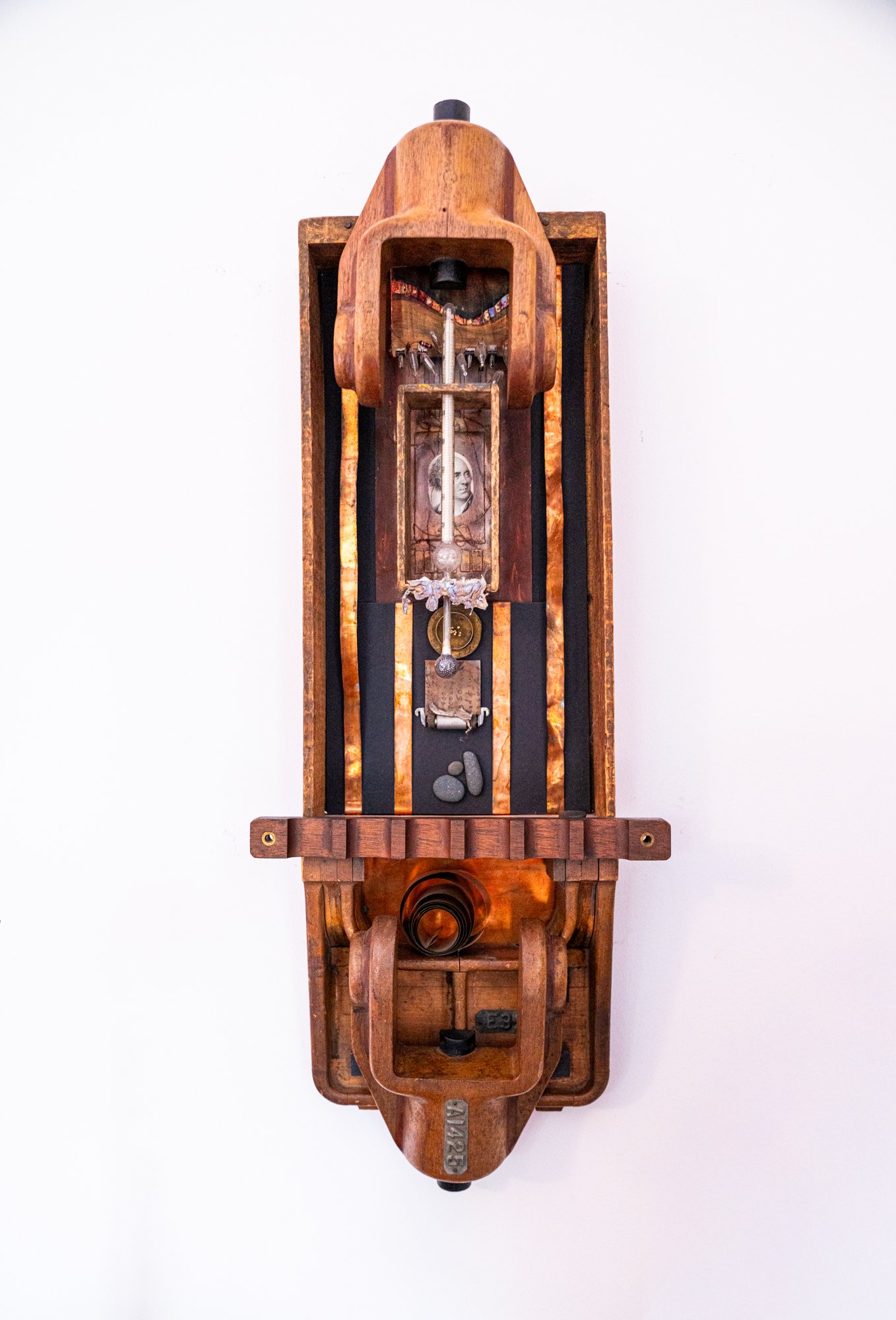 Harbinger - Concept of someone or something foreshadowing the future.
Wooden boxes, wood patterns, copper, thermometer, etching, stones, painted cardboard, cast bronze. 30” x 10.75” x 4.5”. 2013