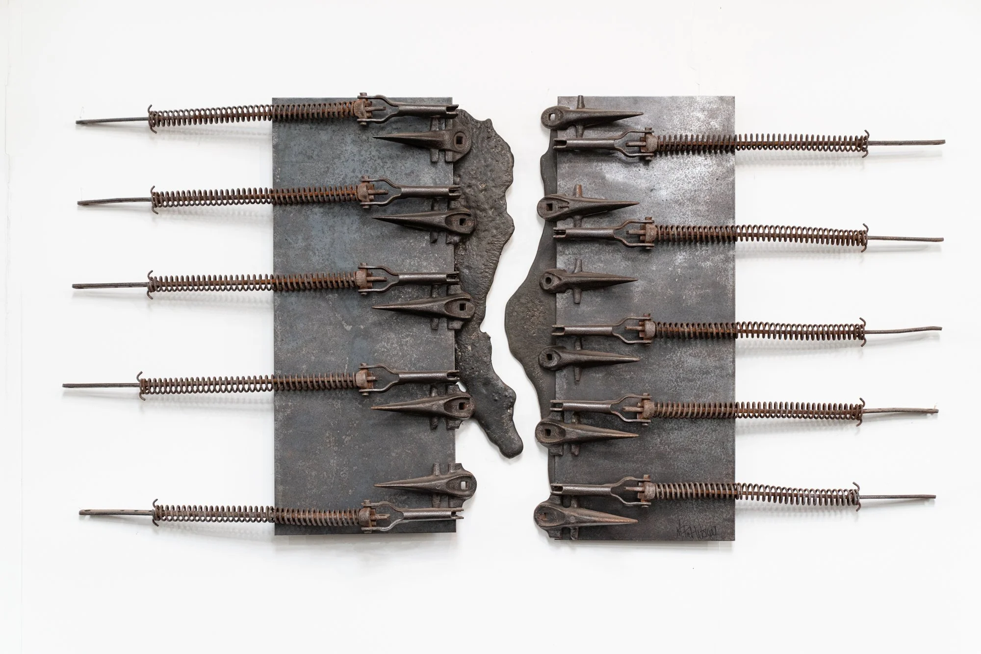 Detached - Inspired by the act of separating but remaining visually connected. cast stainless steel, industrial springs, cutter bar blades.  29” x 59” x 5”. 1995