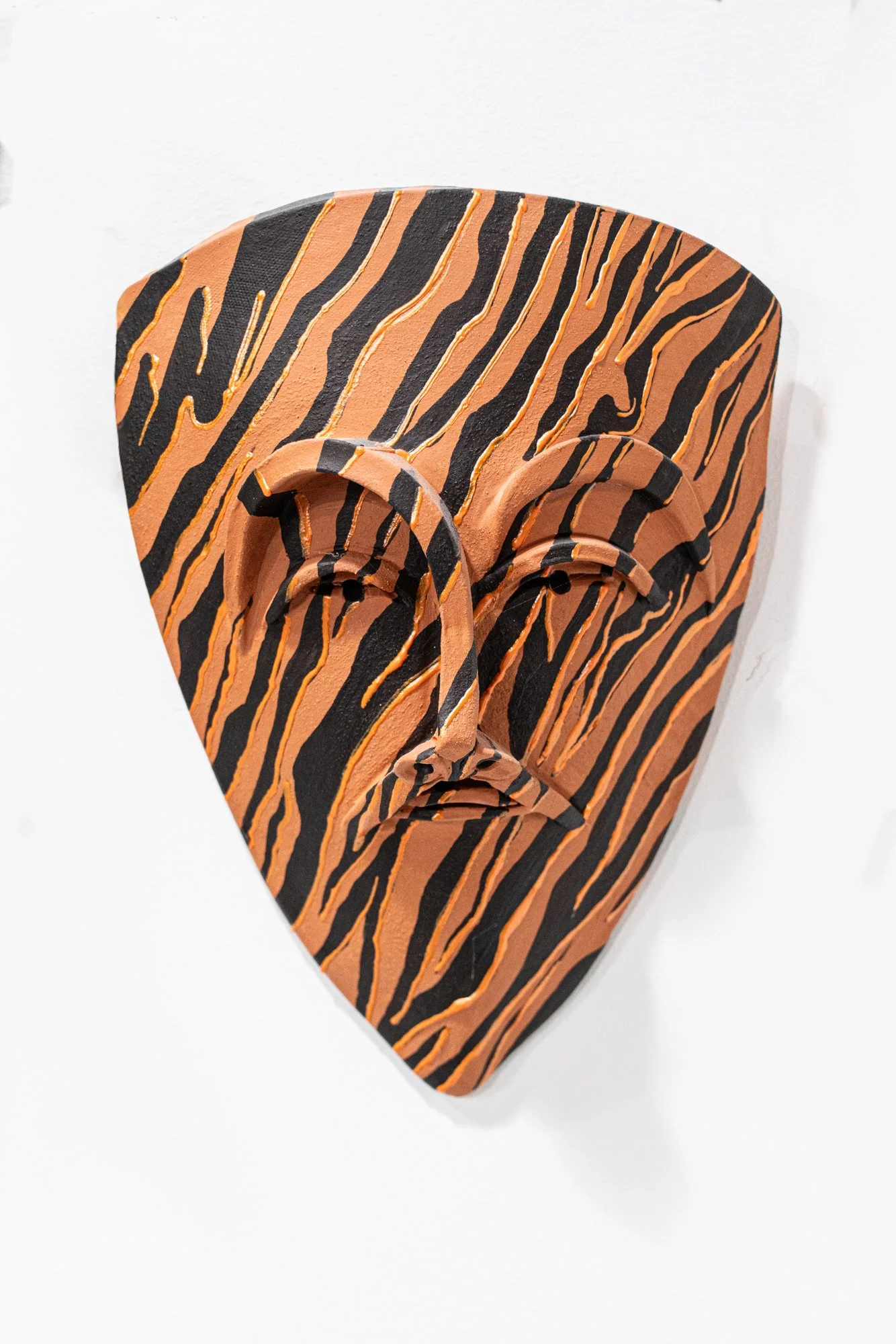Tiger Stripes Mask - Intuitively created. Terra cotta clay, paint. 12’ x 10’ x 3”
