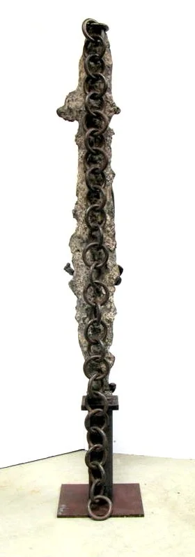 Stone Sentry  -Inspired by guarding or protection. - Welded steel, cast stainless steel, Industrial chain, rock. 78” x 14” x 11”. 2007