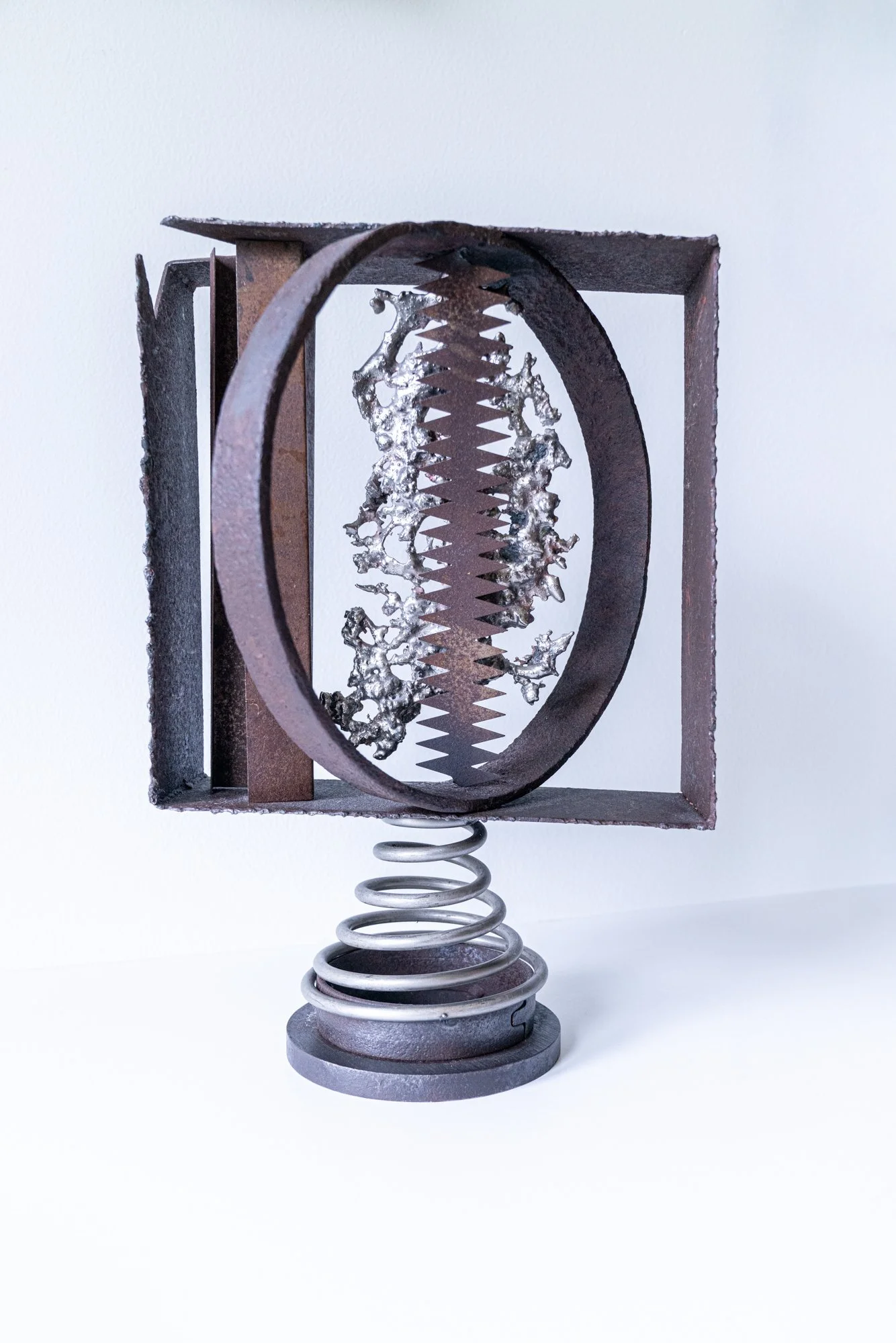 View Finder - Concept of isolating a section of a composition. Welded steel, spring, cast stainless steel, saw blade. 15” x 10.5” x 8.5”. 2020