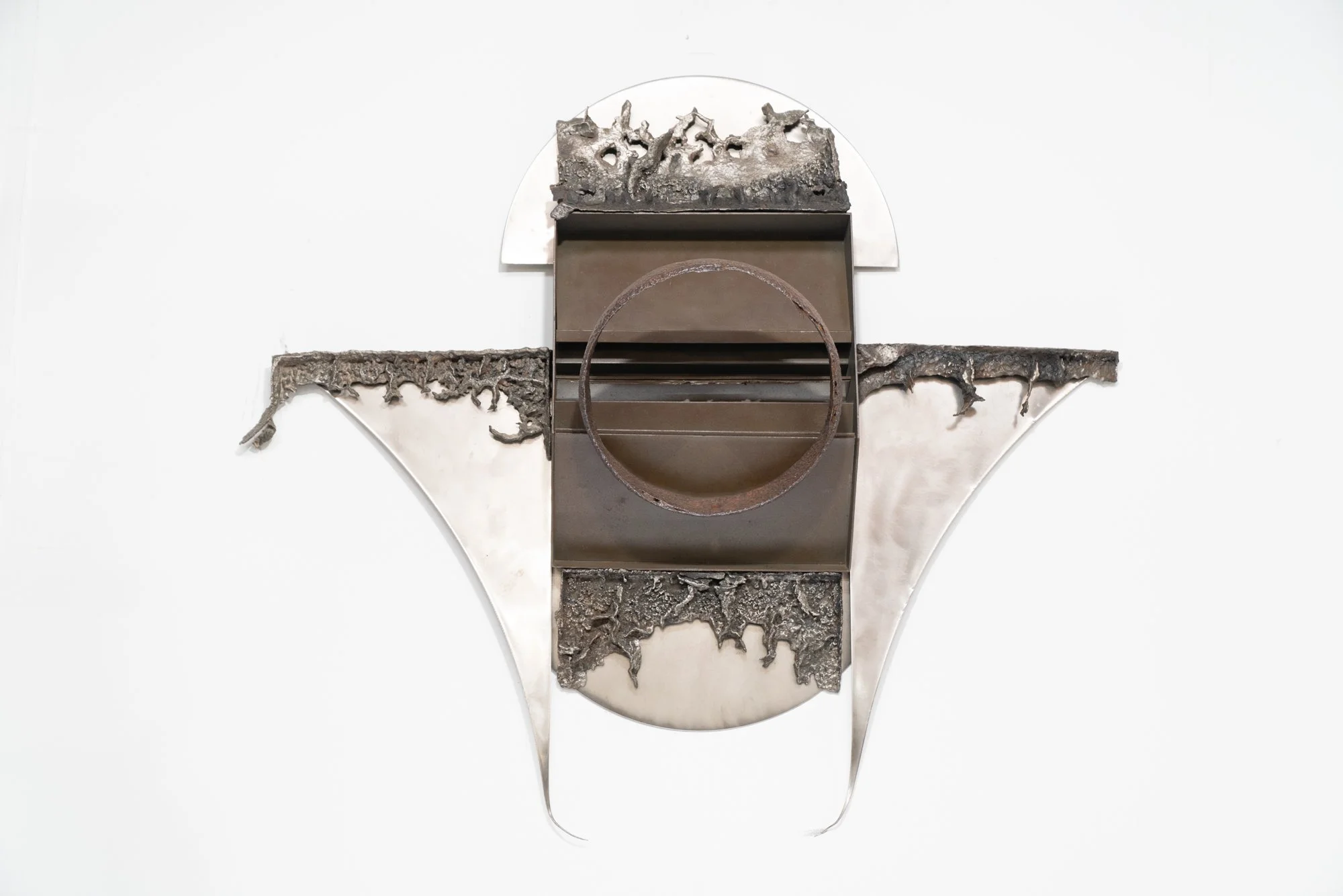 Heavenly - Inspired by the wing-like pieces of steel that appear angelic.
Welded and cast stainless steel, mild steel. 32’ x 36” x 5”. 1993

