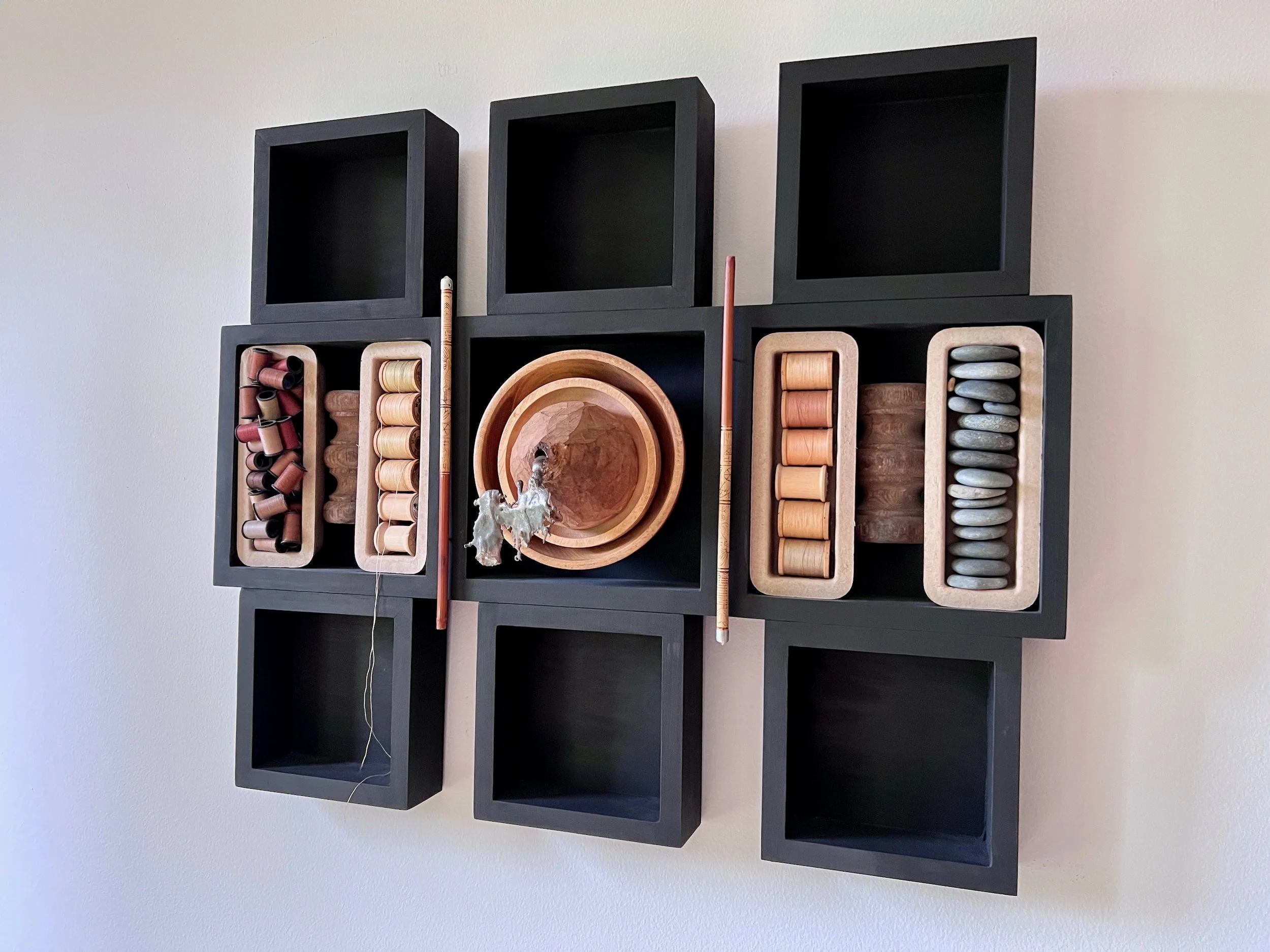 Wall Sushi - Inspired by the neatly, organized food creations. Wood, vintage thread spools, chop sticks, pebbles, cardboard, cast stainless steel, wood bowls. 20” x 24” x 6.25”. 2020