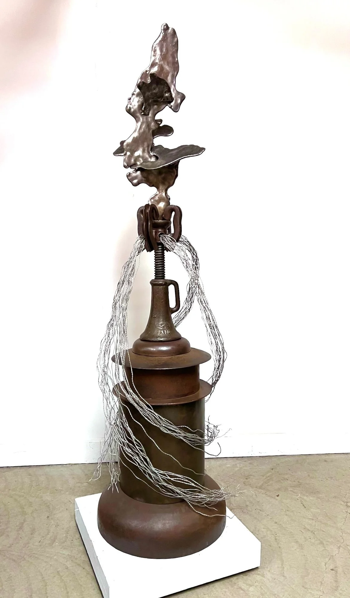 Accession -  Inspired by the concept of acquiring power. Vintage Floor Jack, cast stainless steel, deconstructed propane tank, plow disc, welded steel. 8.5’ x 33” x 33”. 2021
