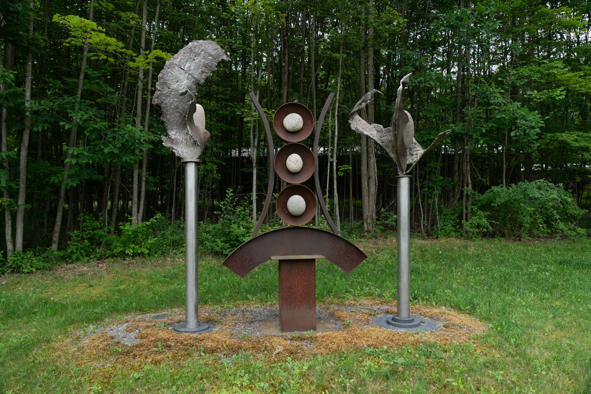 Artifacts I - Inspired by the industrial cast stainless steel forms from a local defunct steel manufacturing plant that serve as artifacts from that time period. Welded steel, cast stainless steel, rocks. Overall 9’ x 11’ x 3’.  2009