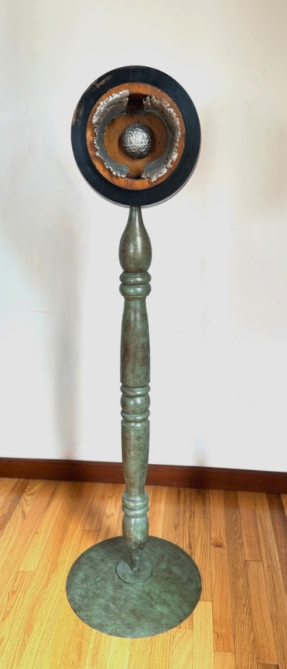Centered Focus - Exploring the concept of a concentrated focal point. Wood pattern piece, cast stainless steel, vintage post, steel. 59” x 17.5” x 17.5”. 1992