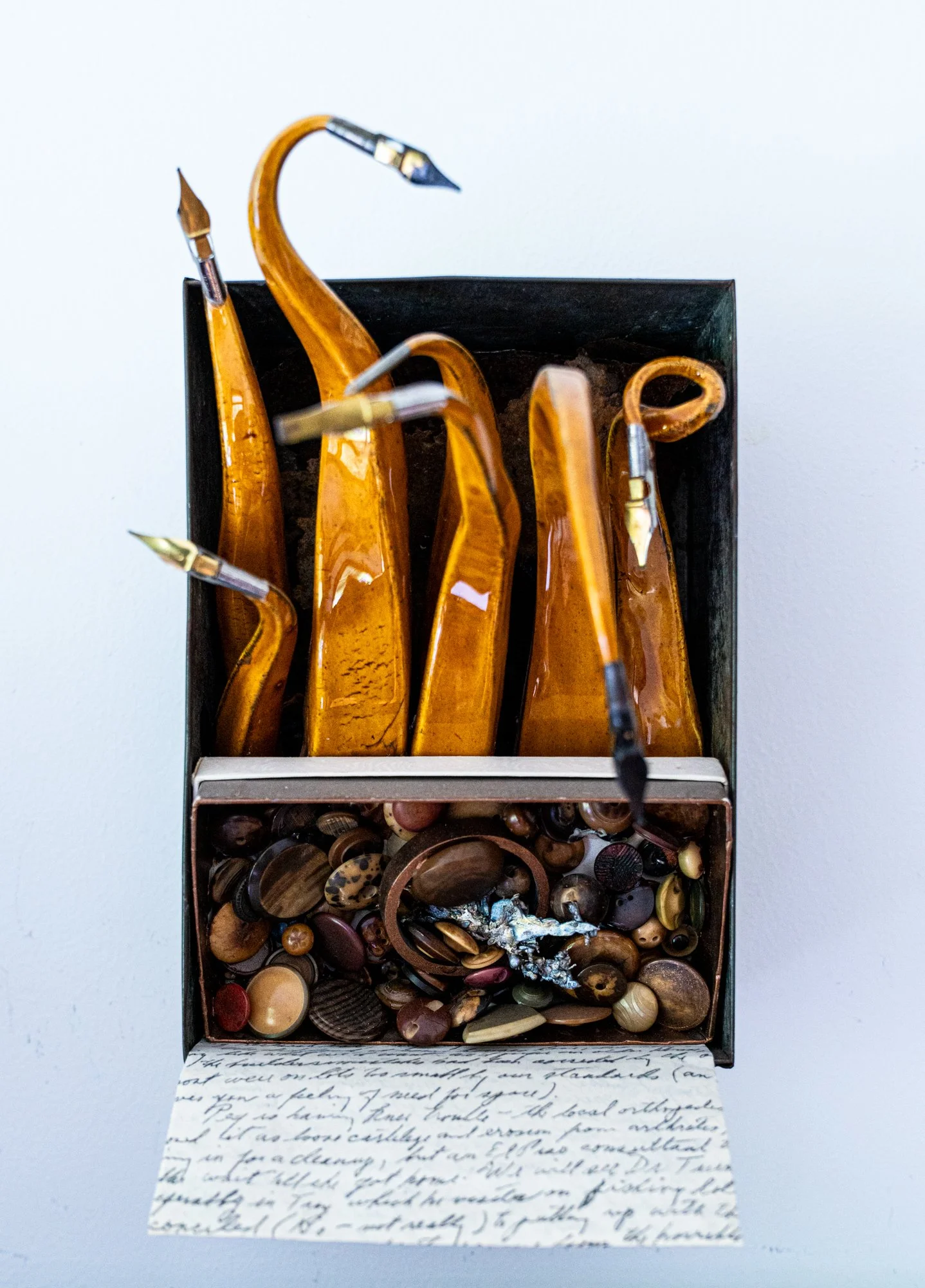Scripted - Inspired by cursive writing. Vintage metal box, clay, letter written in cursive, buttons, bronze, steel, pen nibs. 12” x 16” x 7.5” 2010