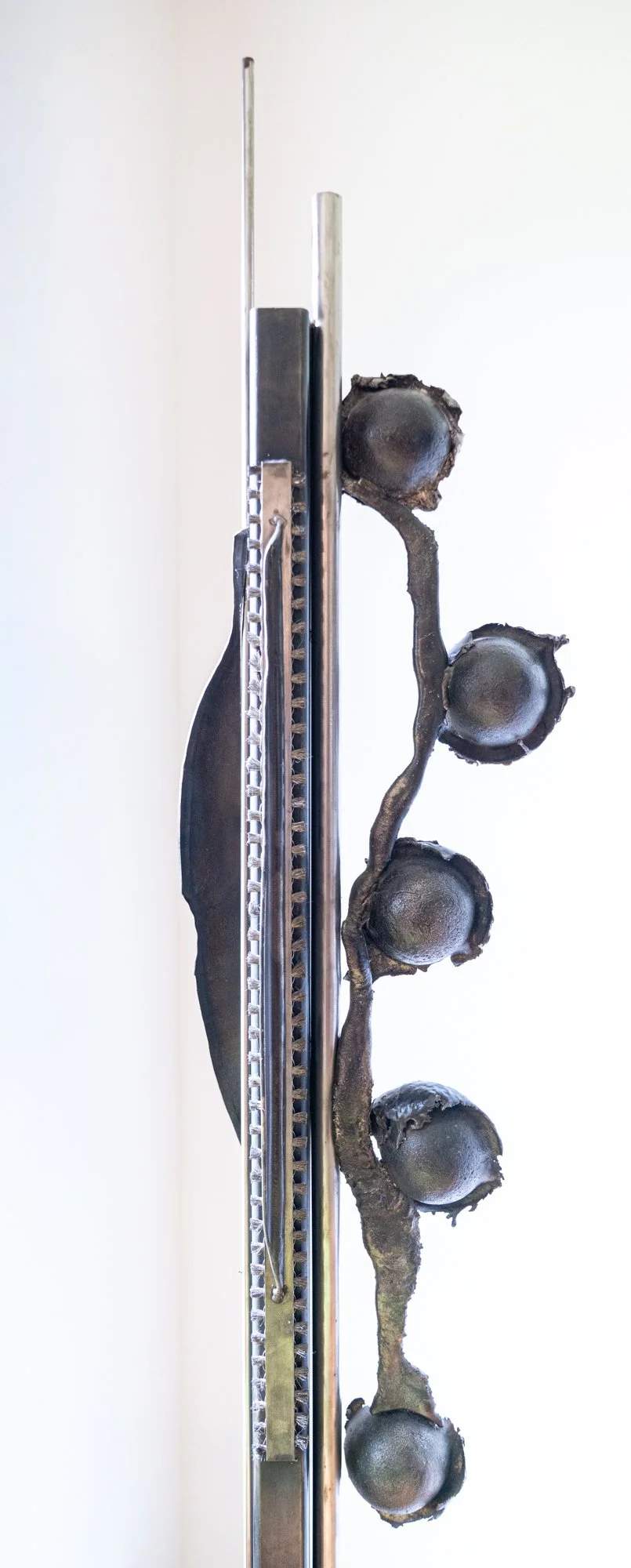Totem - (detail) A marker of ancestry. Cast stainless, welded steel, industrial brushes. 7’ x 1’ x 10” 1987