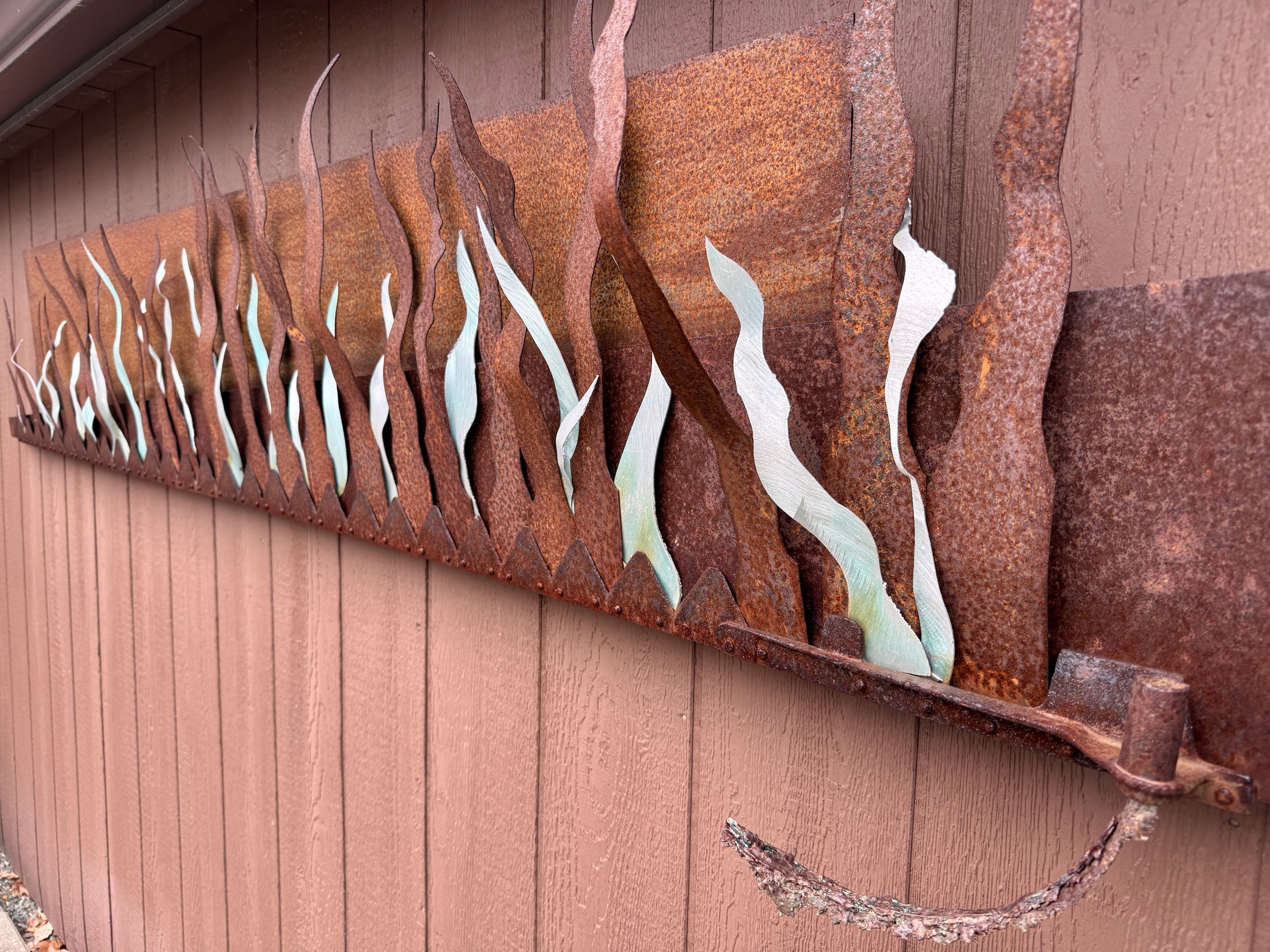 Horizontal Flame-Scape - Inspired by fire. Welded steel, plasma cut aluminum - 15” x 7’ x 6”. 1999
