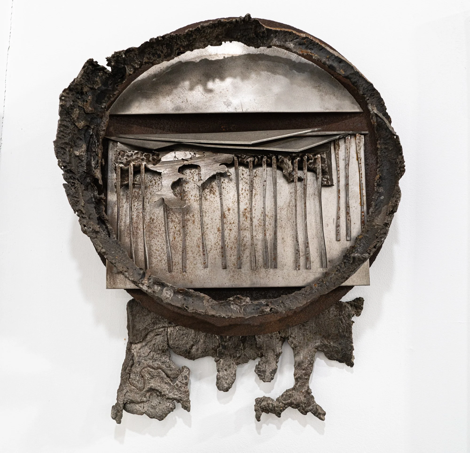 Plate Shift Divide - Inspired by the shifting plates of the earth. Welded steel, cast stainless steel. 44’ x 17” x 4”. 1995.